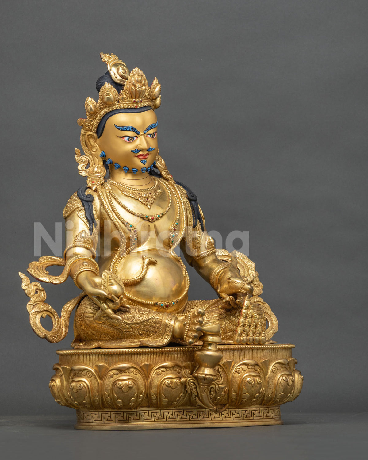 Right side view of Dzambhala copper statue holding Chintamani wish-granting jewel