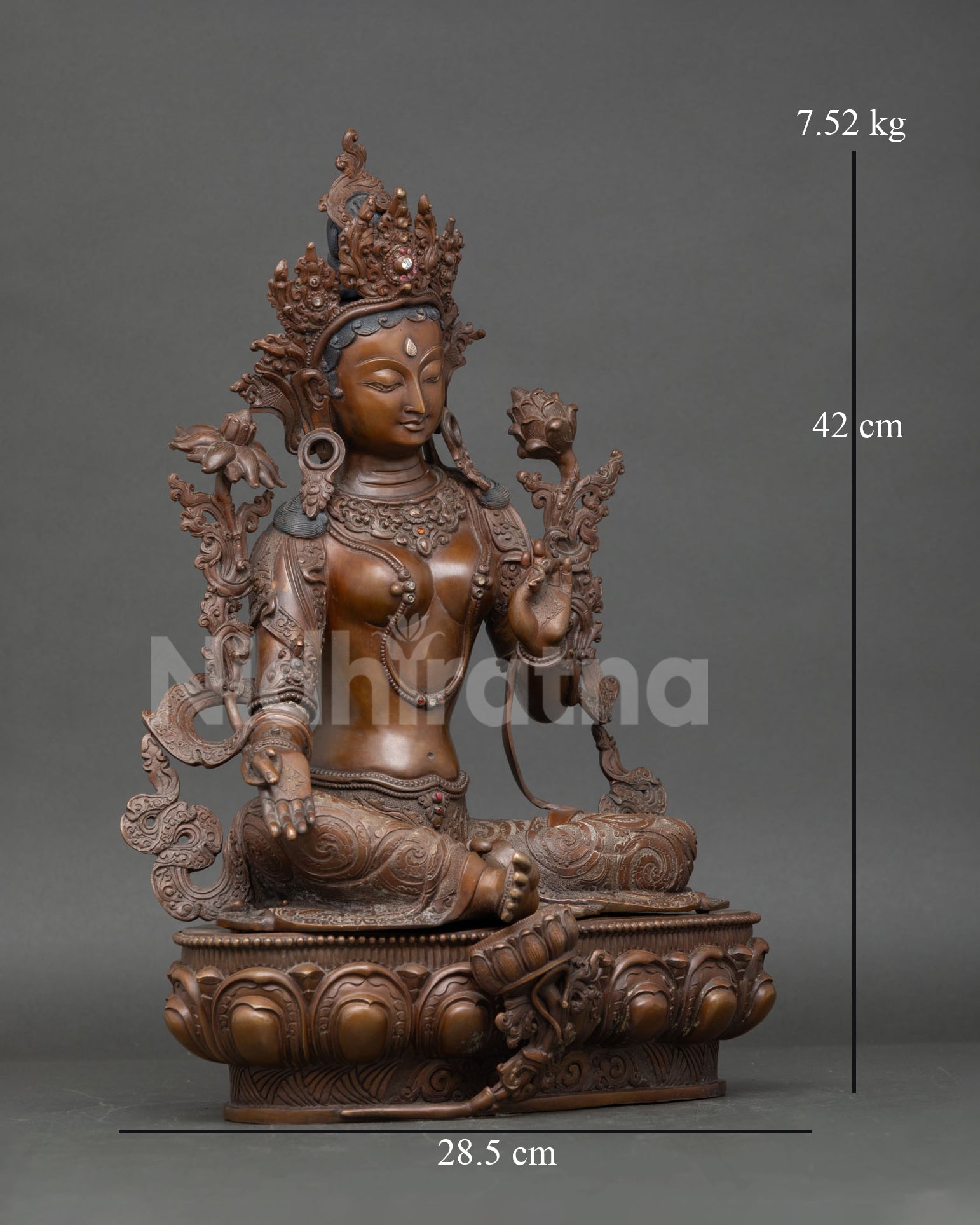Right side view of Green Tara statue holding blue lotus in Lalitasana posture