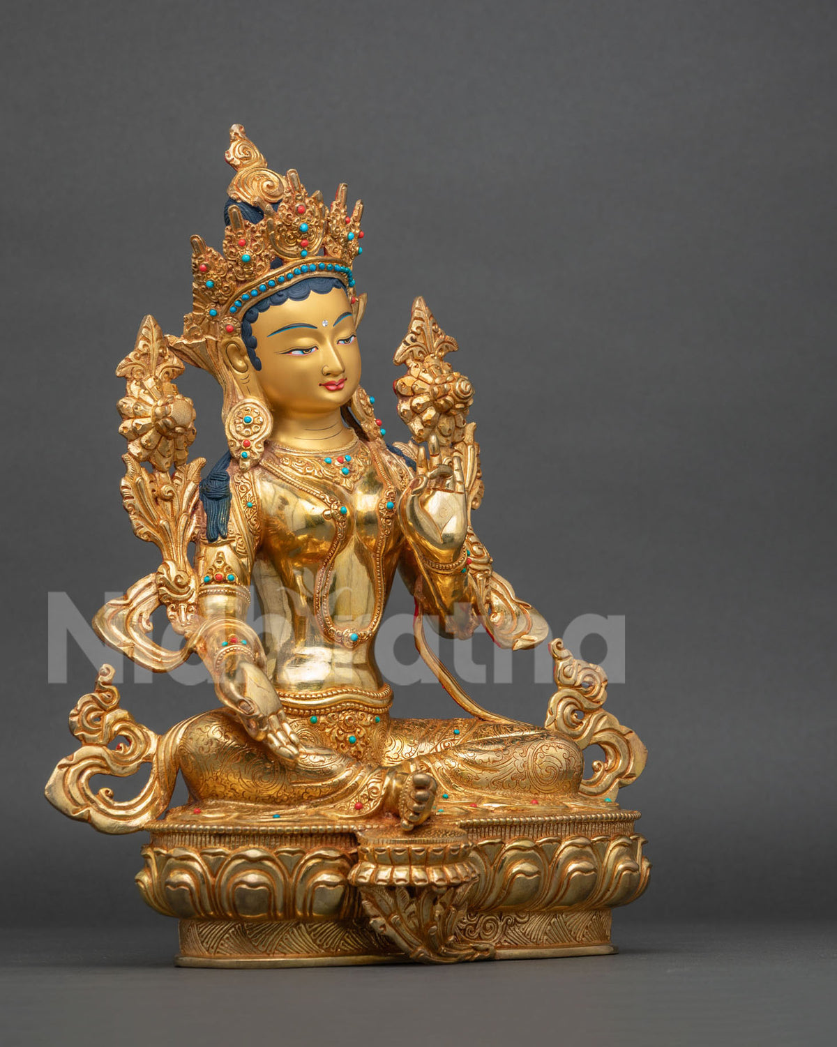 Right side view of Green Tara statue seated in royal ease pose on a lotus seat with 24K gold gilding