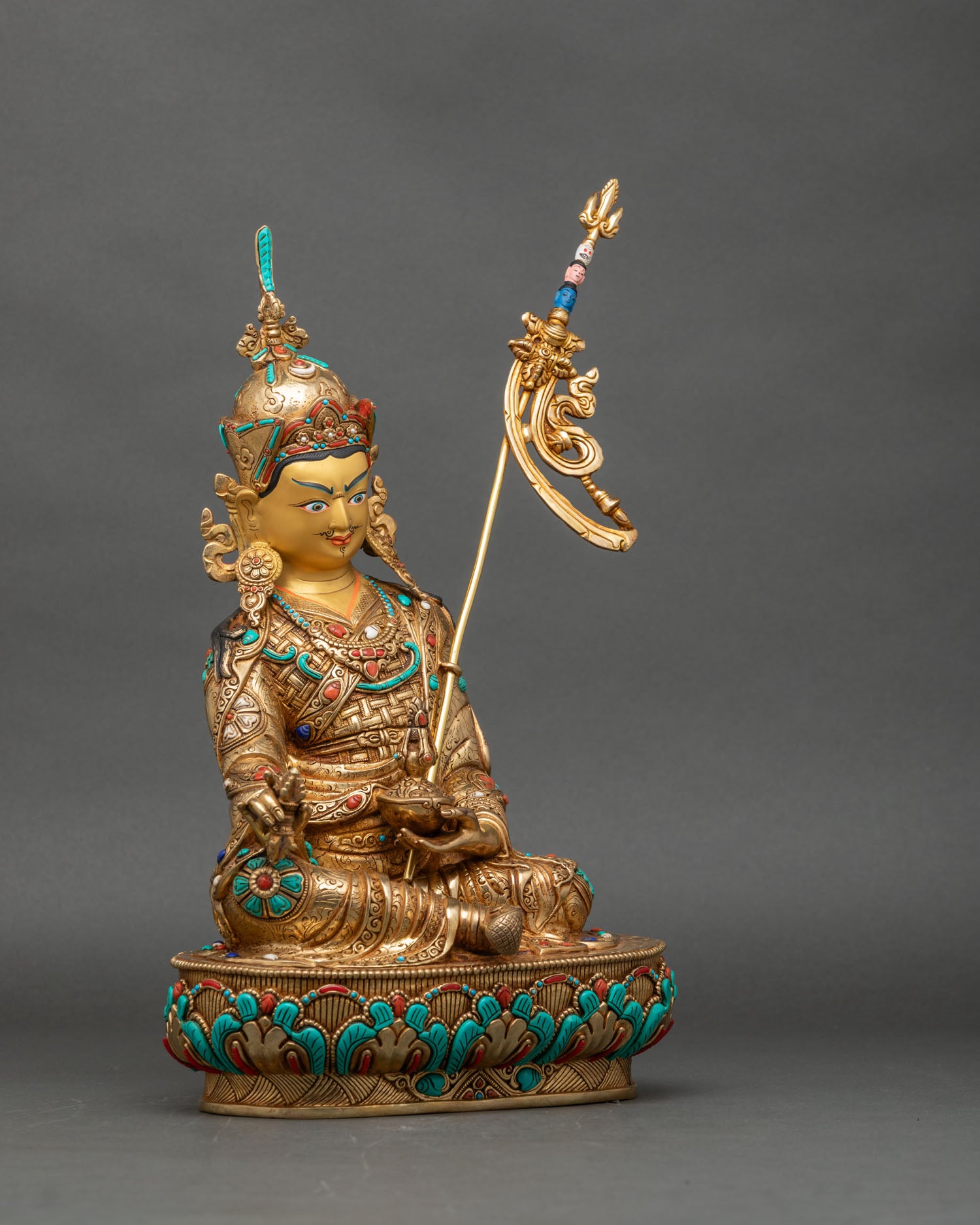 Right side view of Guru Rinpoche statue, lotus pedestal and traditional Tibetan details