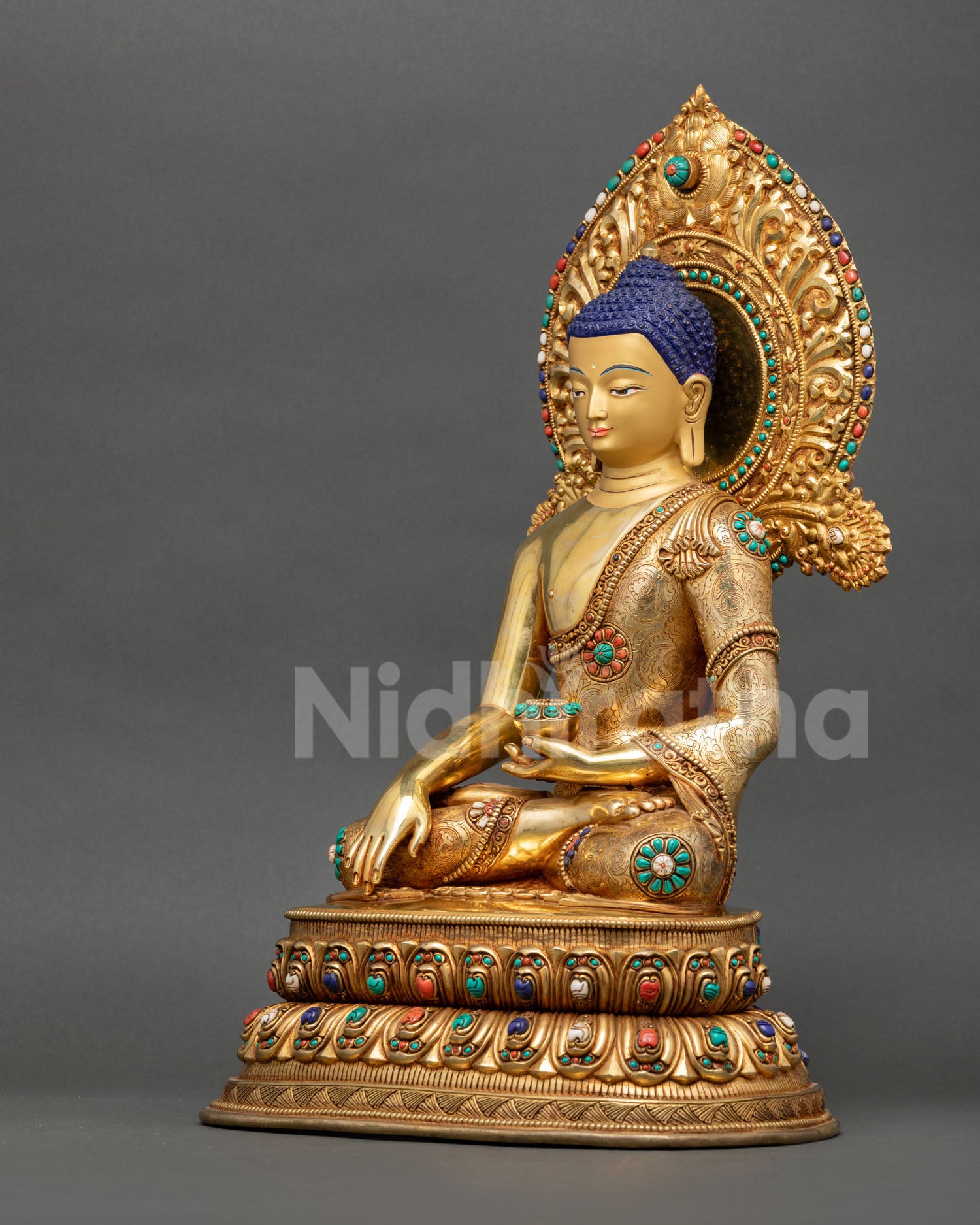 Right side view of handcrafted Shakyamuni Buddha statue holding a begging bowl and displaying intricate Himalayan Buddhist craftsmanship.