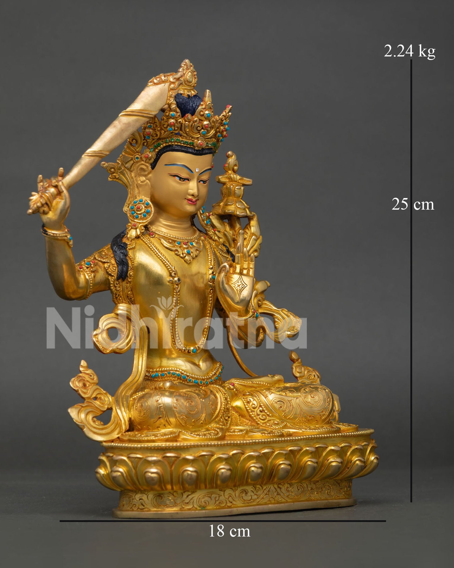 right side view of manjushri statue displaying sacred sword and lotus pedestal