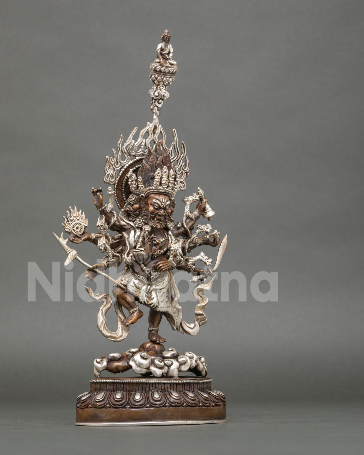 Right side view of oxidized copper Ucchusma statue with silver-plated tiger-skin garment and flaming halo
