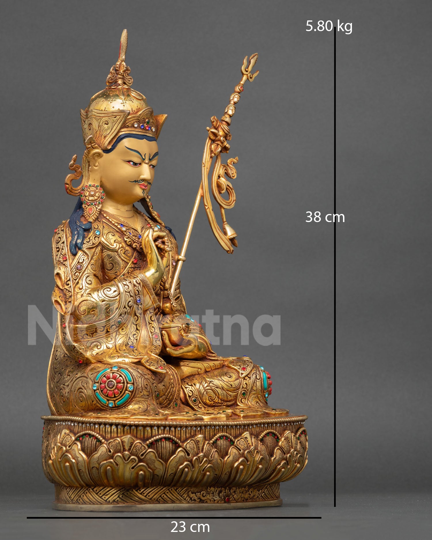 right side view of tsokye dorje statue seated on lotus pedestal with khatvanga