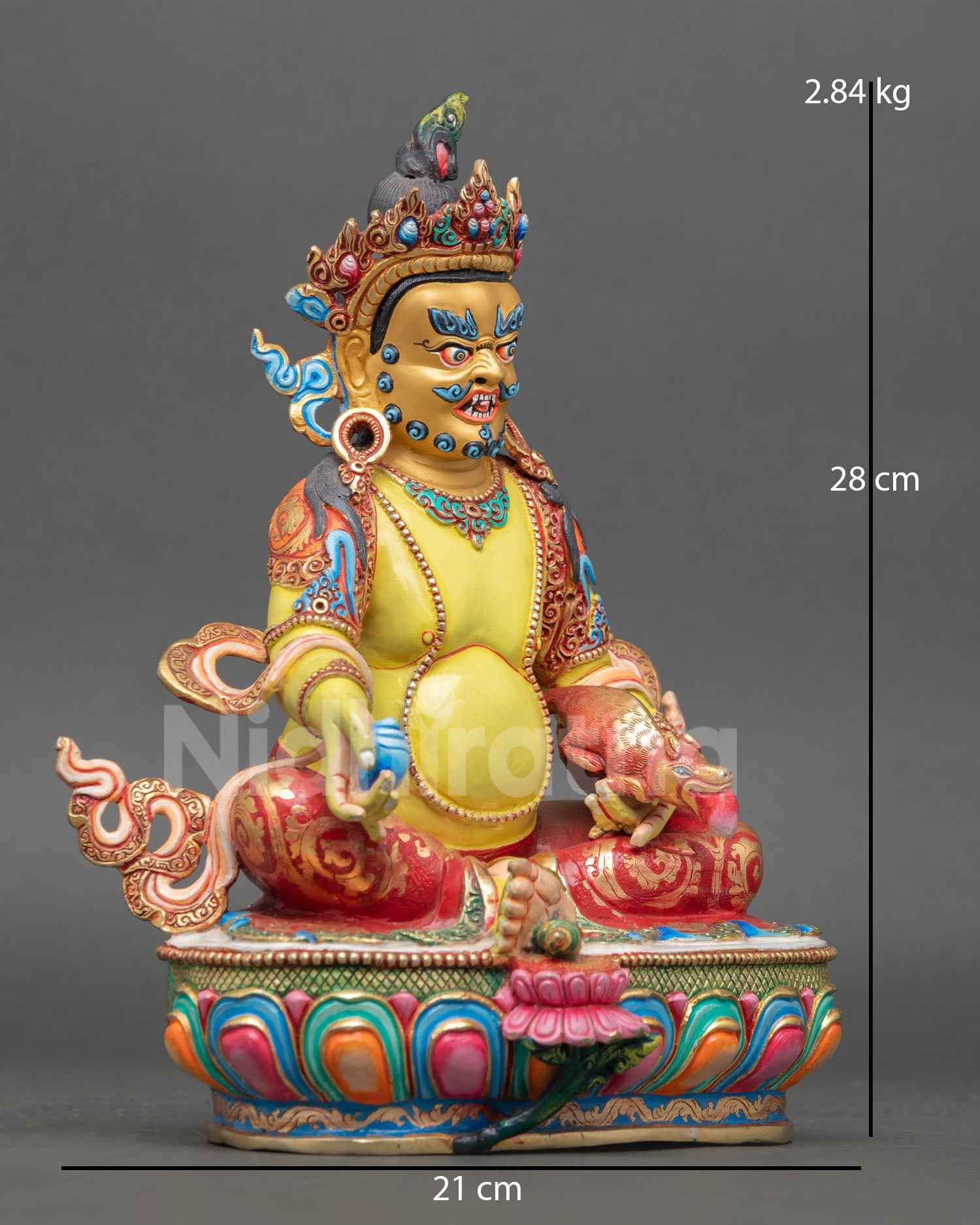 right view dzambhala statue holding citron fruit mongoose wrathful protector deity