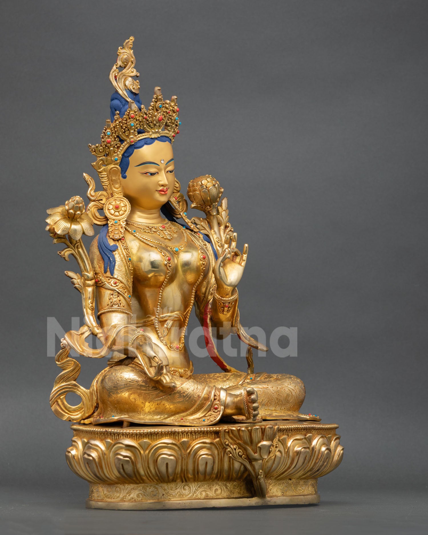 Right view of Green Tara sculpture with utpala flower and lotus seat craftsmanship