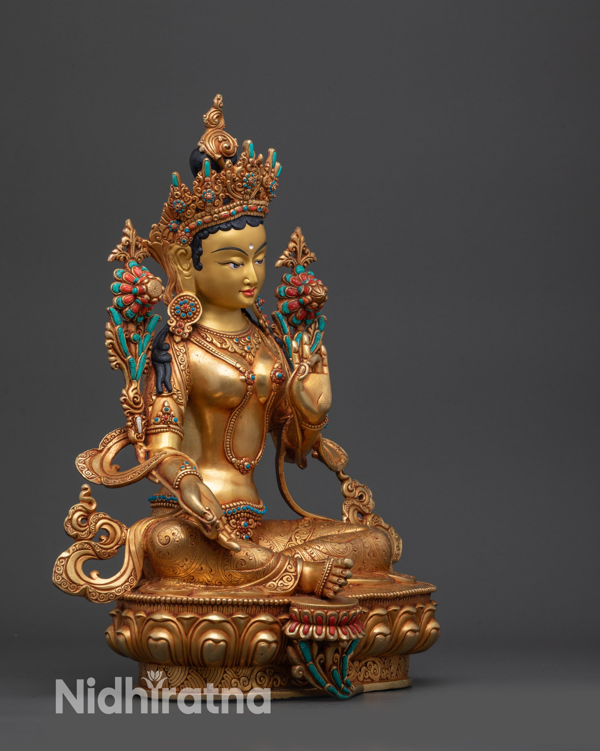 right view side green tara himalayan statue seated in royal ease pose