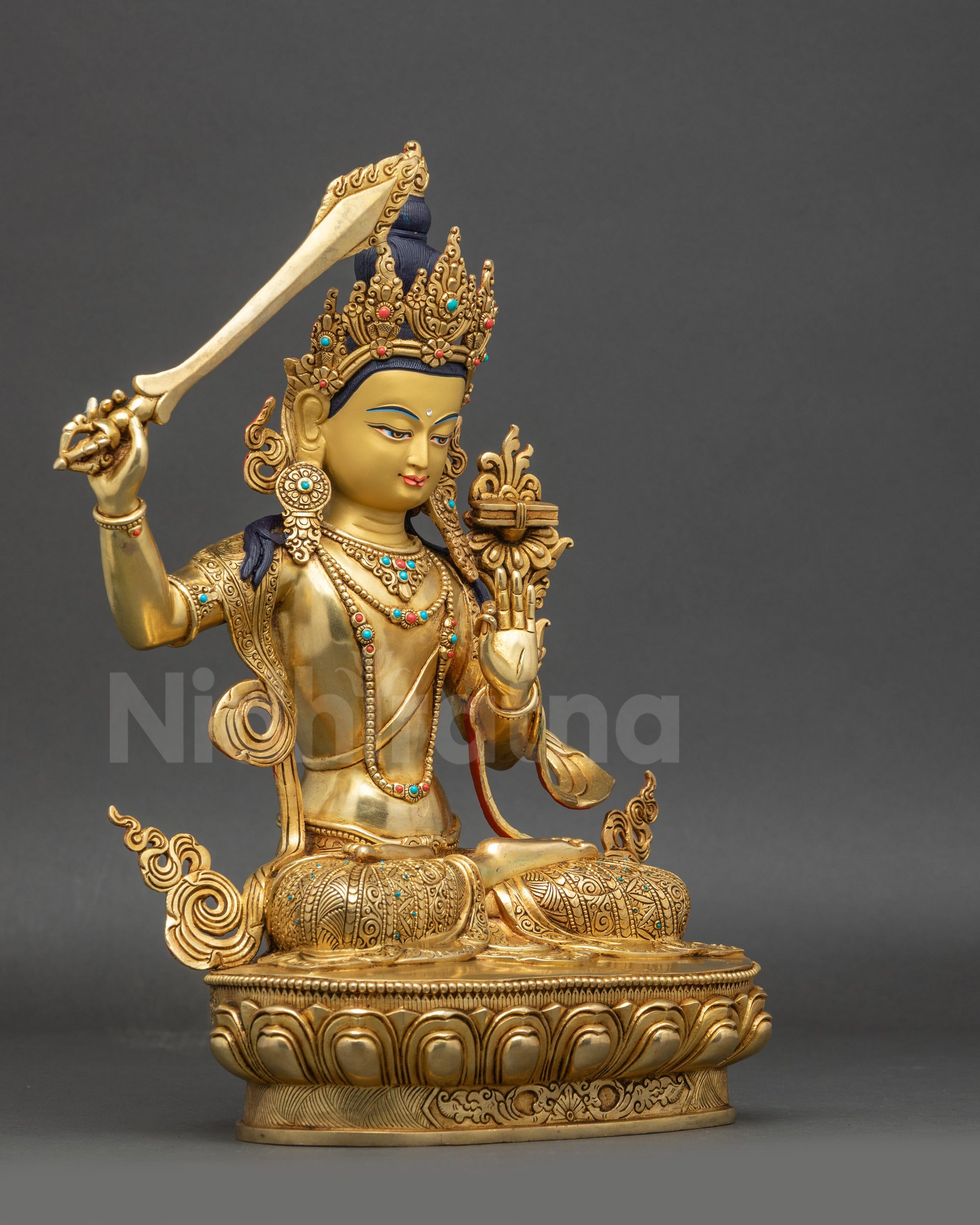 right view side of Manjushri statue showing swirling robes and lotus pedestal carvings