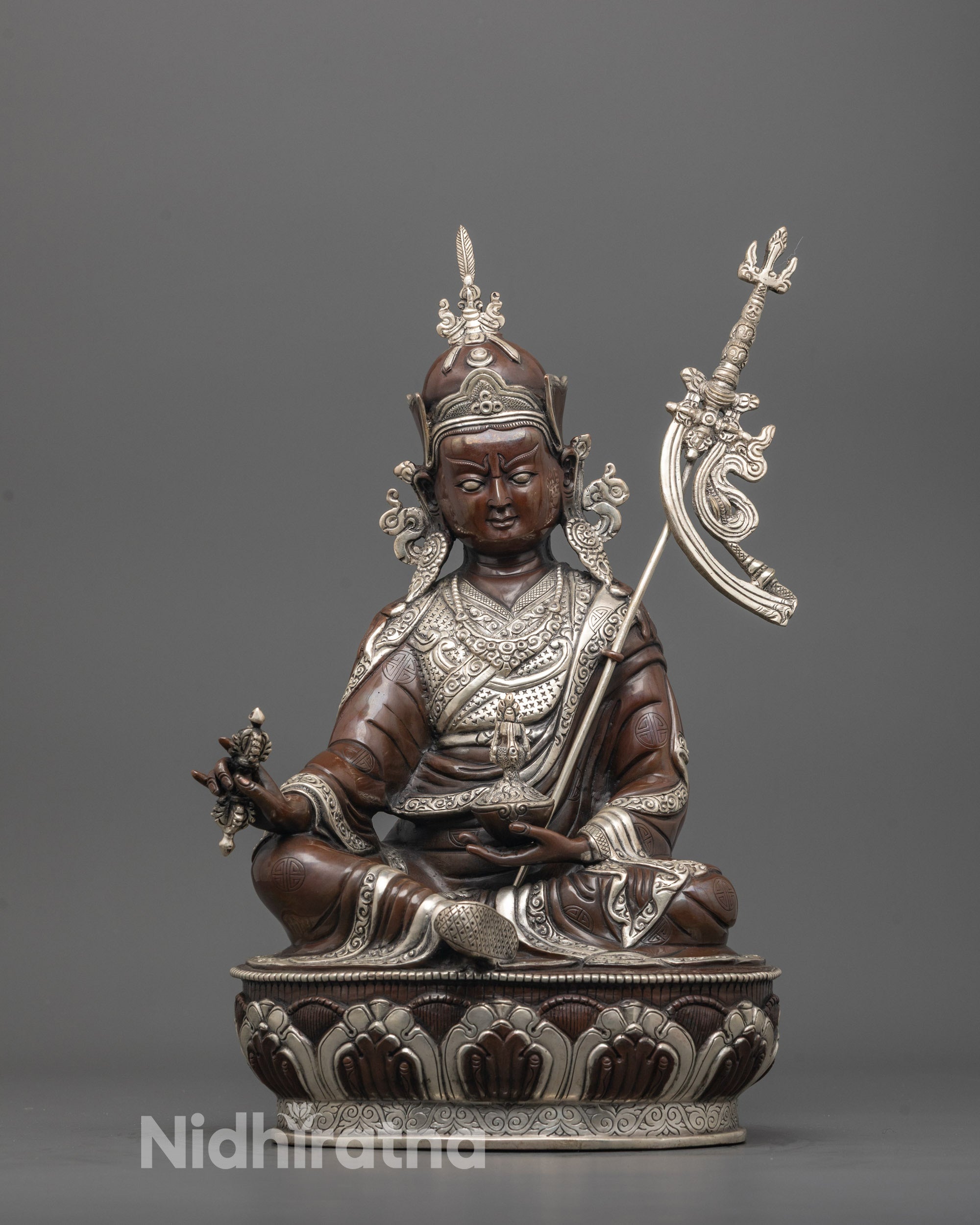 sacred padmasambhava statue front view with silver-plated lotus seat and oxidized copper finish