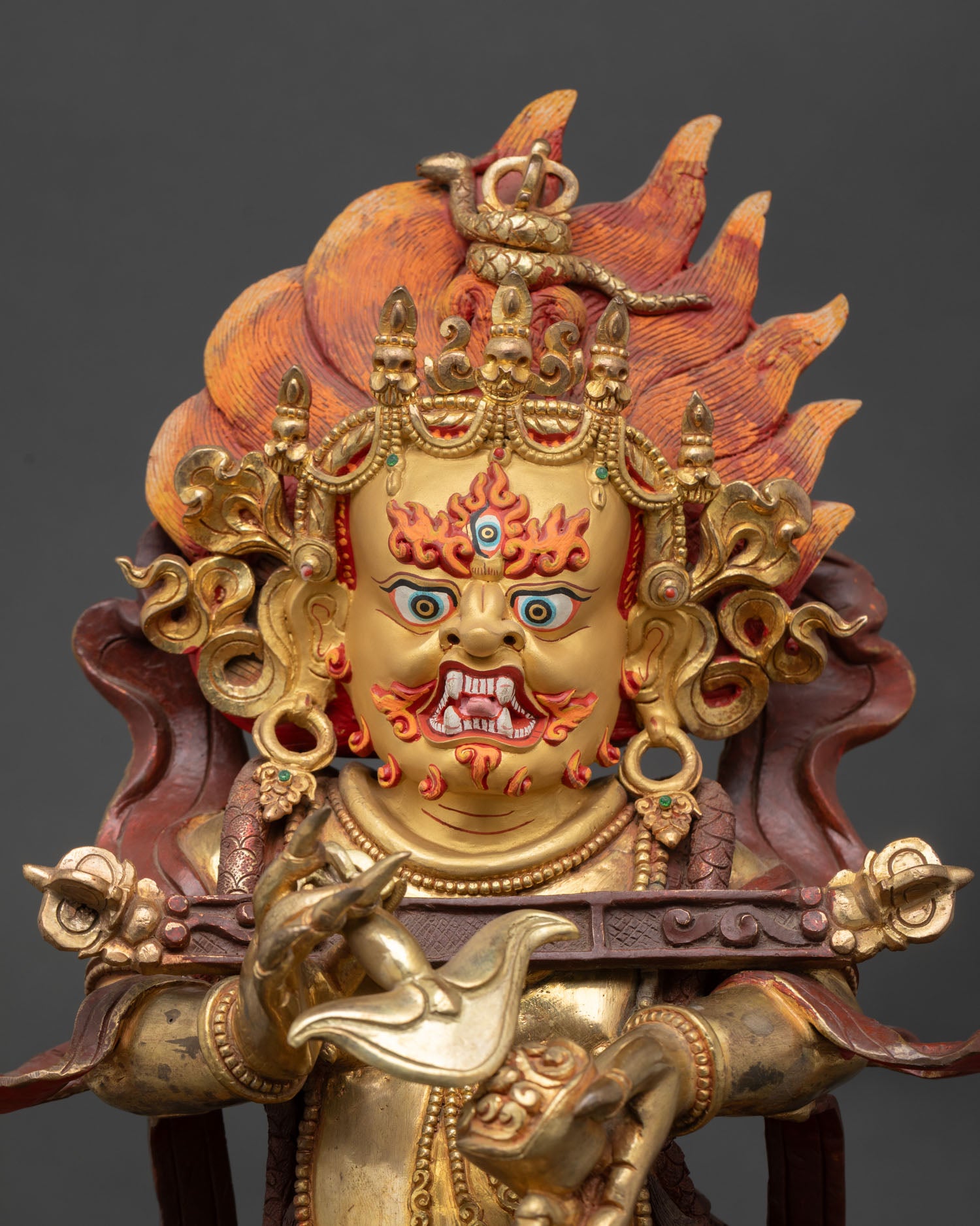 Sakya Mahakala statue close up view fierce expression Sakya Tibetan deity gold painted details sacred Buddhist art
