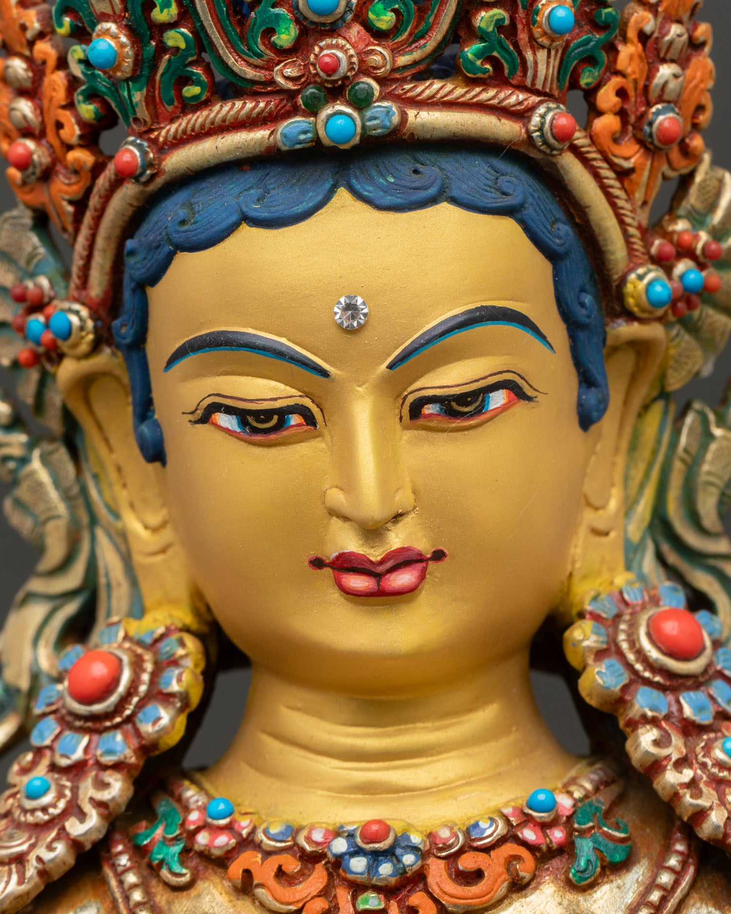 saraswati face close up, gold painted serene expression with crown and halo
