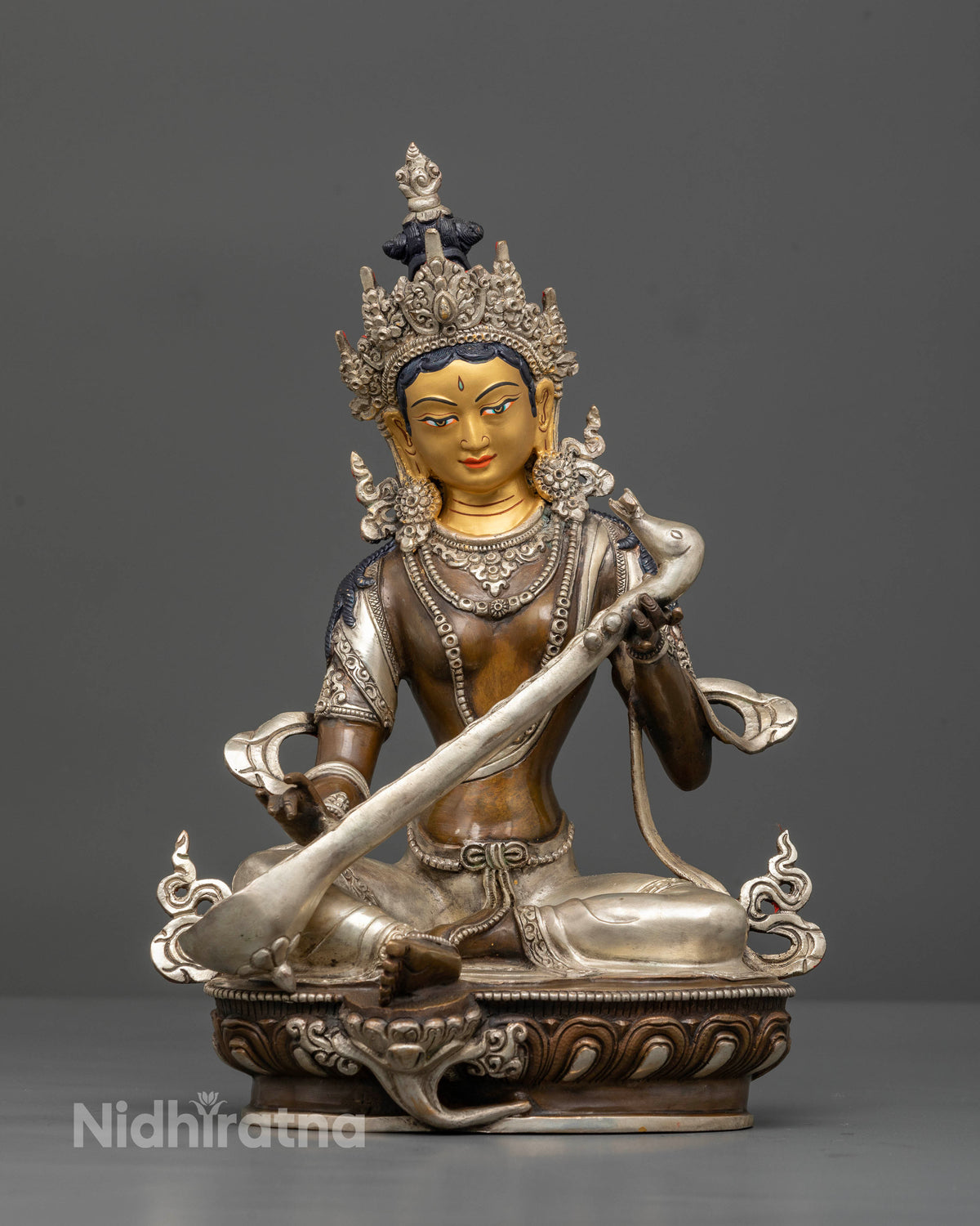 Saraswati goddess statue seated on lotus with veena, handcrafted by Newari artisans in Nepal