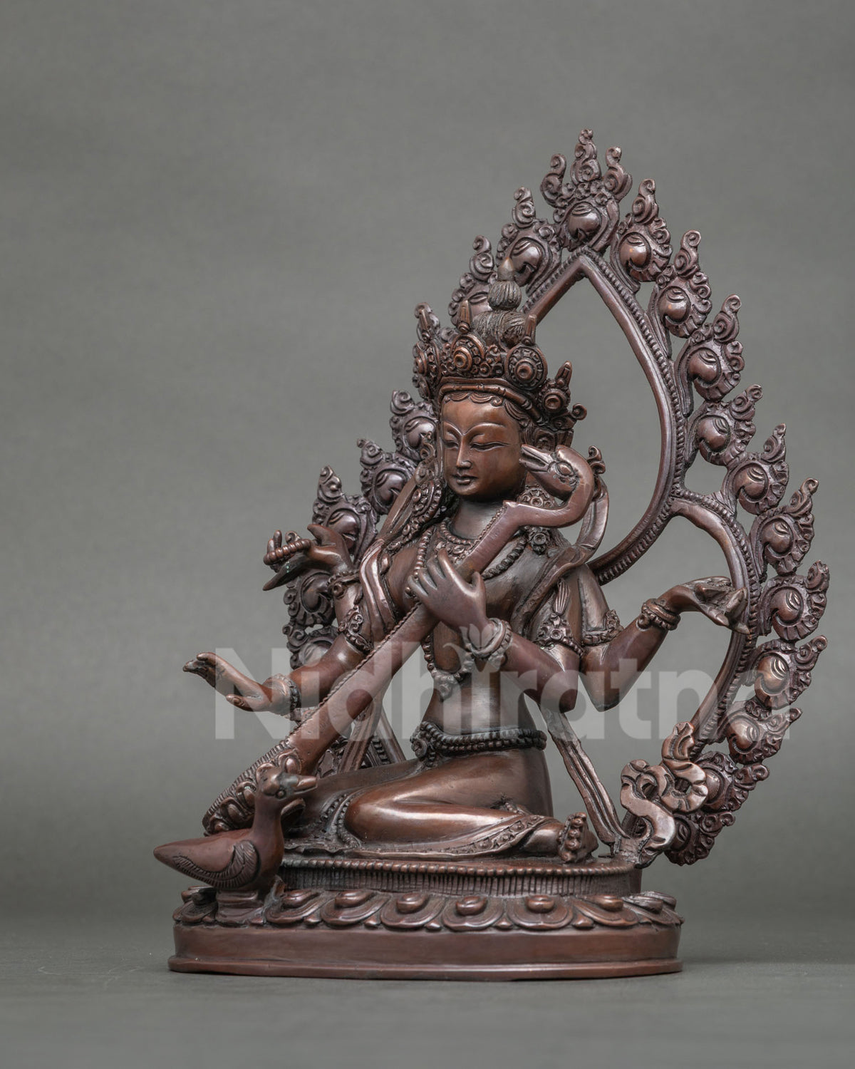 Saraswati Statue featuring a hand carved lotus pedestal and floral halo.