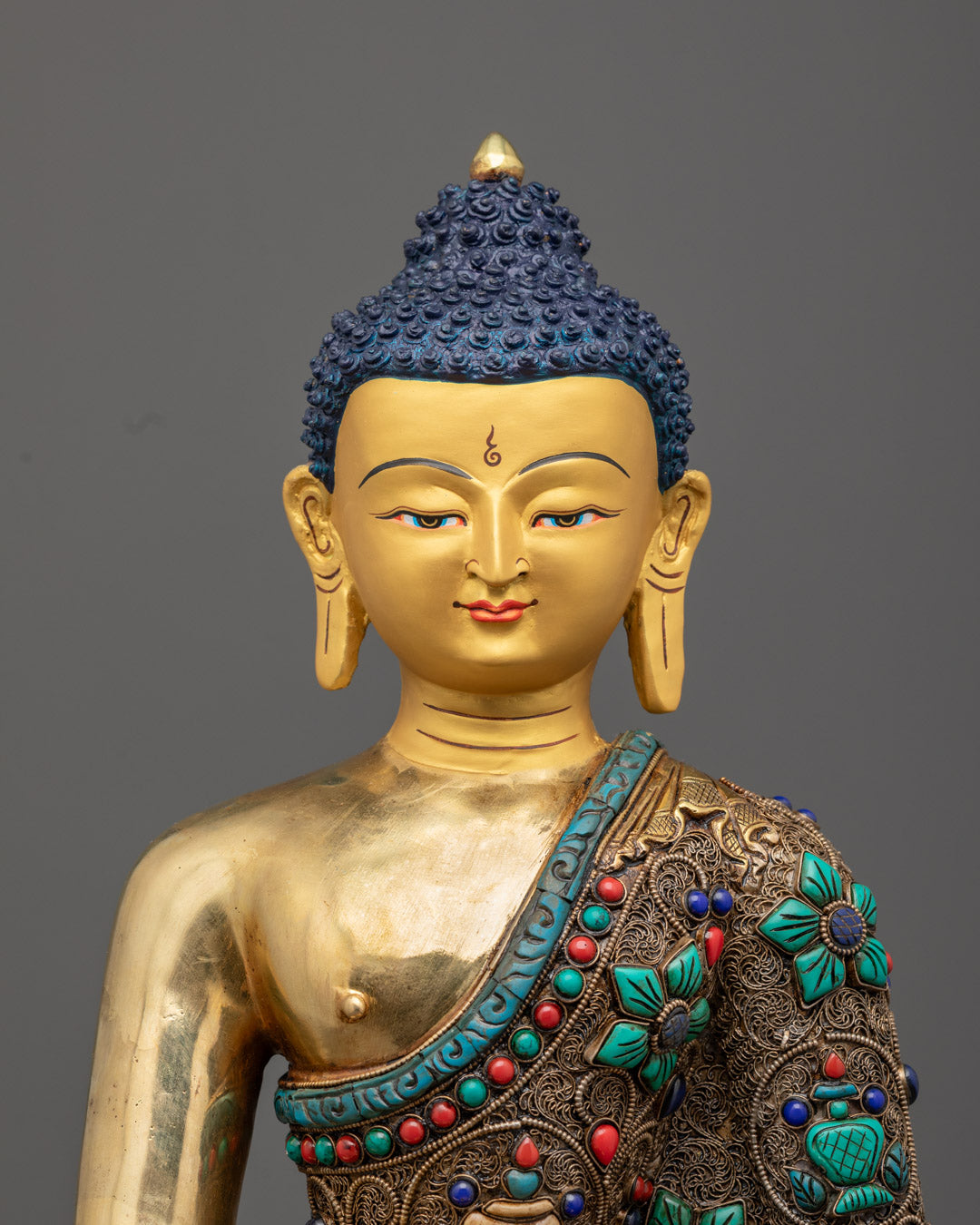 semi-precious stones turquoise, coral, and lapis lazuli adorning Amitabha Buddha statue