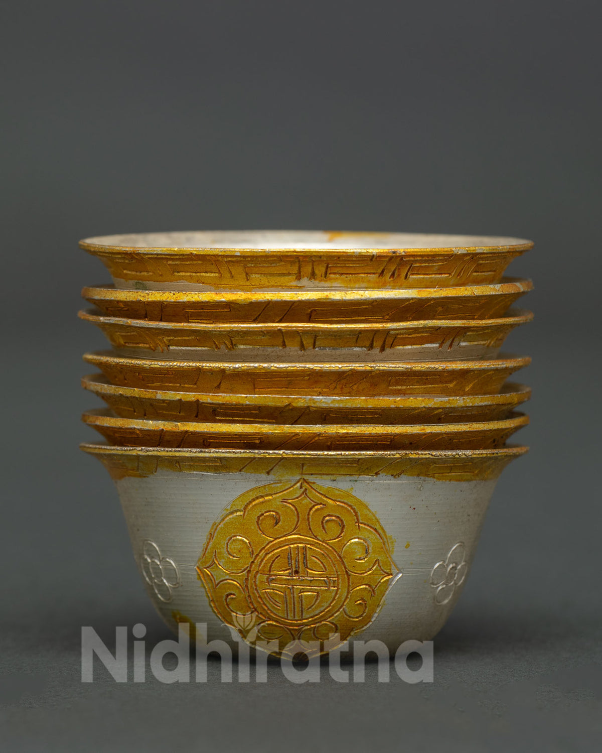 Seven Buddhist water offering bowls with gold and silver plated copper