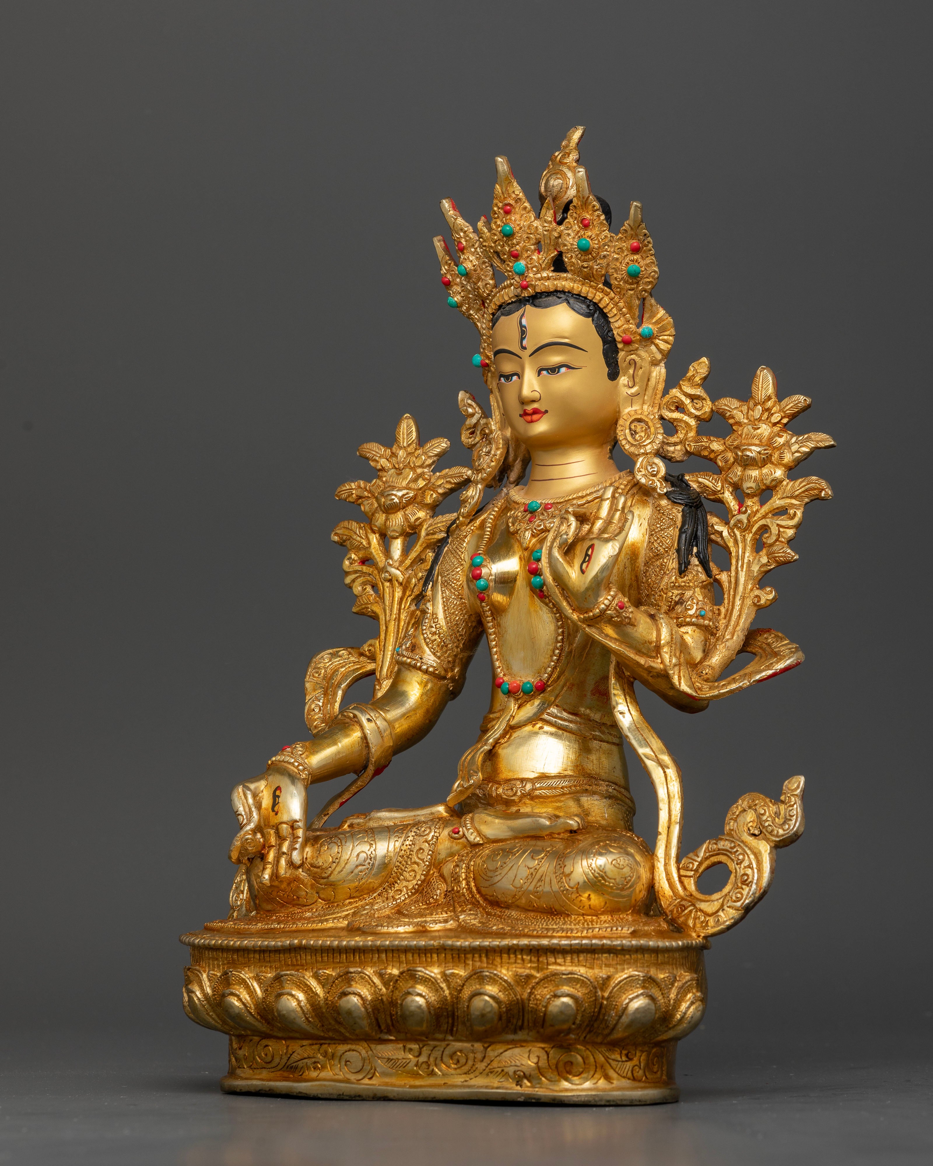 Seven-eyed White Tara deity seated on an ornate lotus pedestal with detailed sacred robes