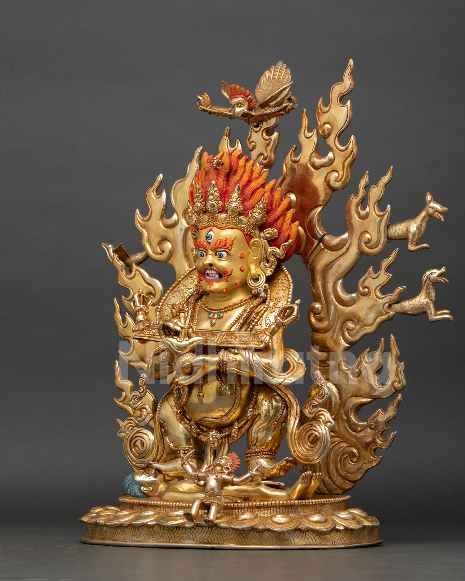 shakya mahakala statue left side view, detailed copper sculpture with flowing robes, engraved ornaments and protective deity symbolism