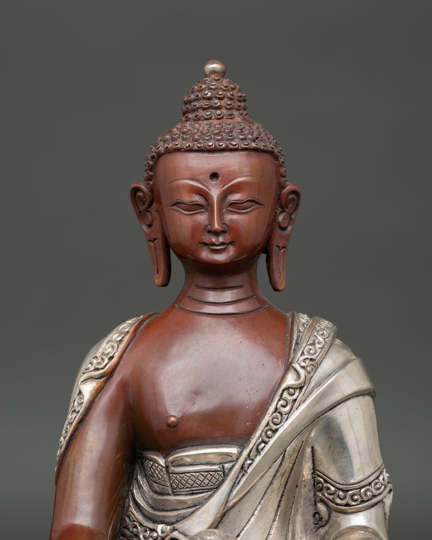 Shakyamuni buddha face showing serene expression and detailed nepalese craftsmanship.