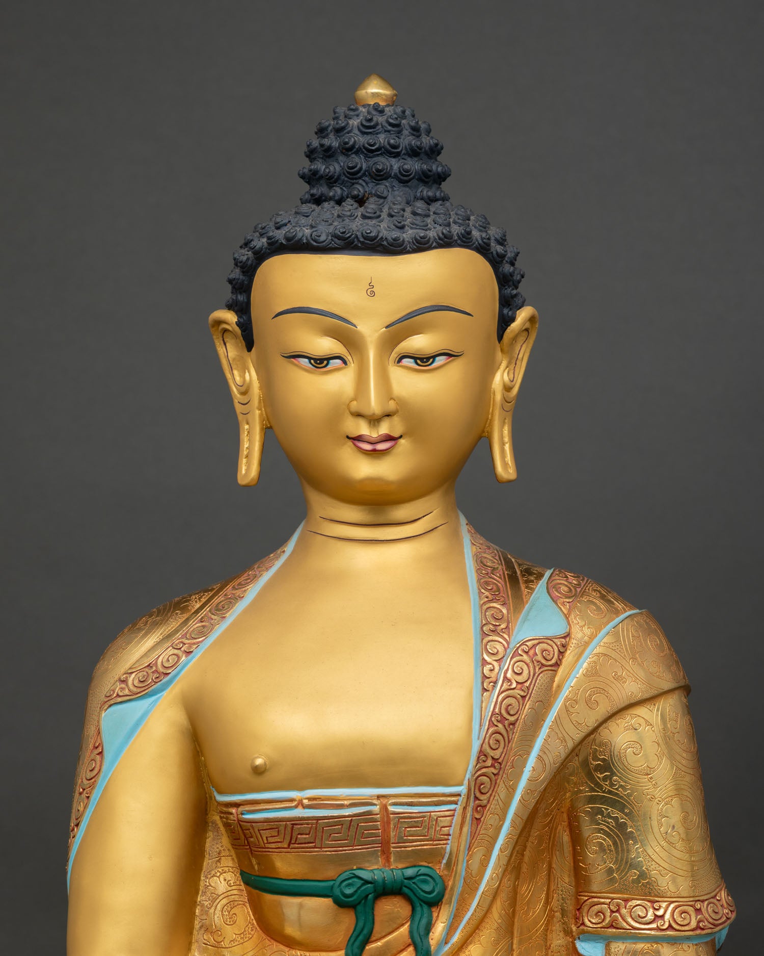 Shakyamuni Buddha featuring gold painted face and hand painted acrylic details
