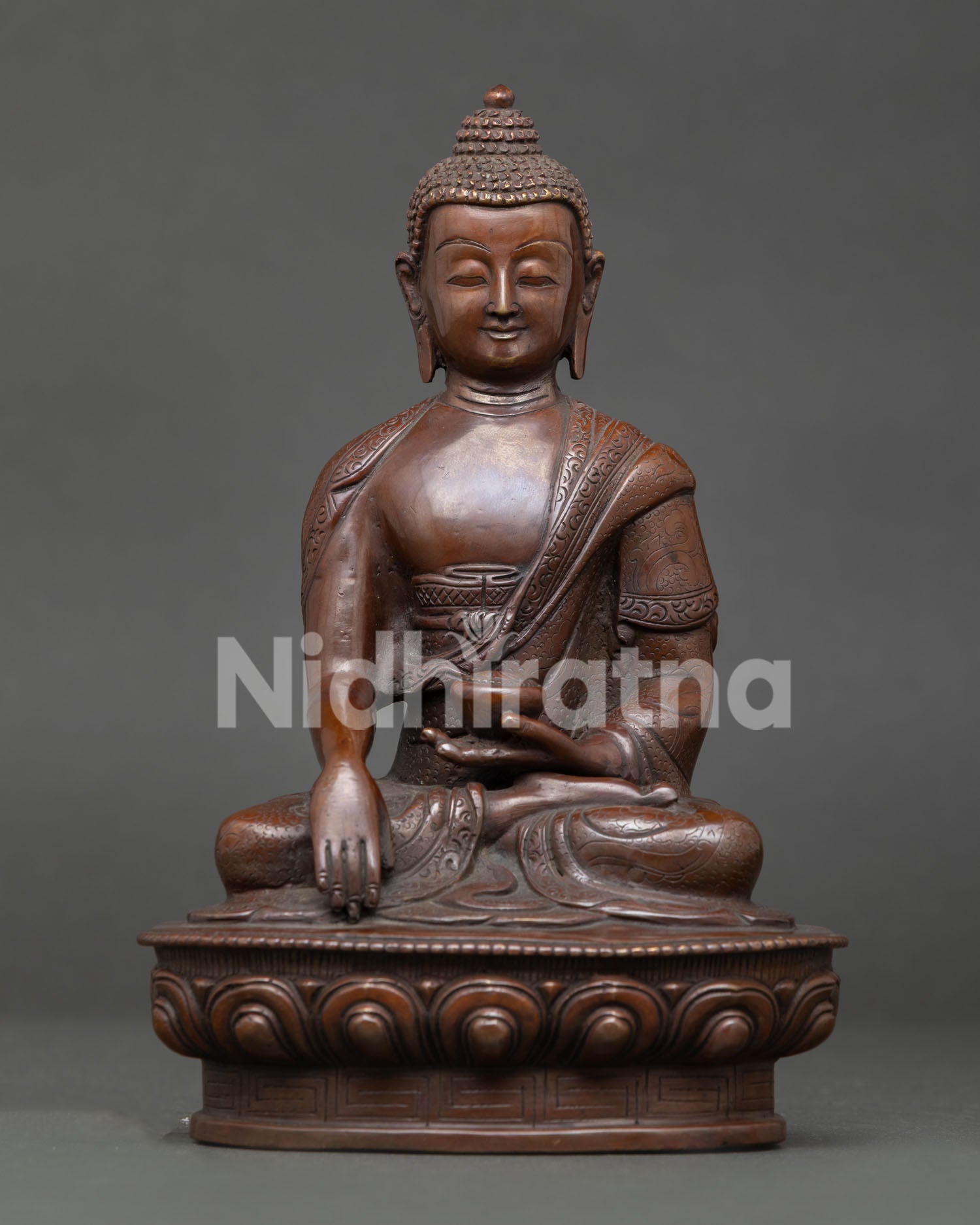 Shakyamuni Buddha meditation sculpture seated on lotus throne holding begging bowl with earth touching mudra symbolizing enlightenment.