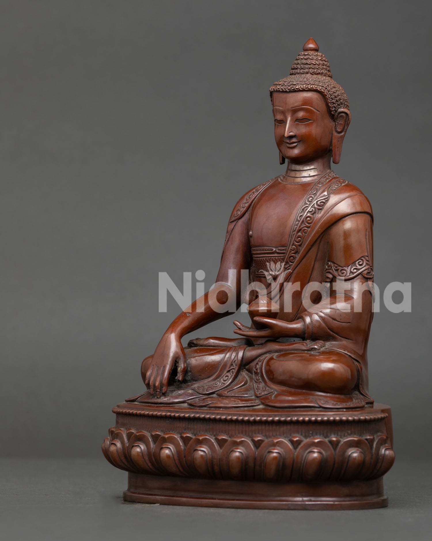 Shakyamuni Buddha sculpture displaying earth touching mudra, begging bowl, lotus seat, and traditional Nepalese artistry.