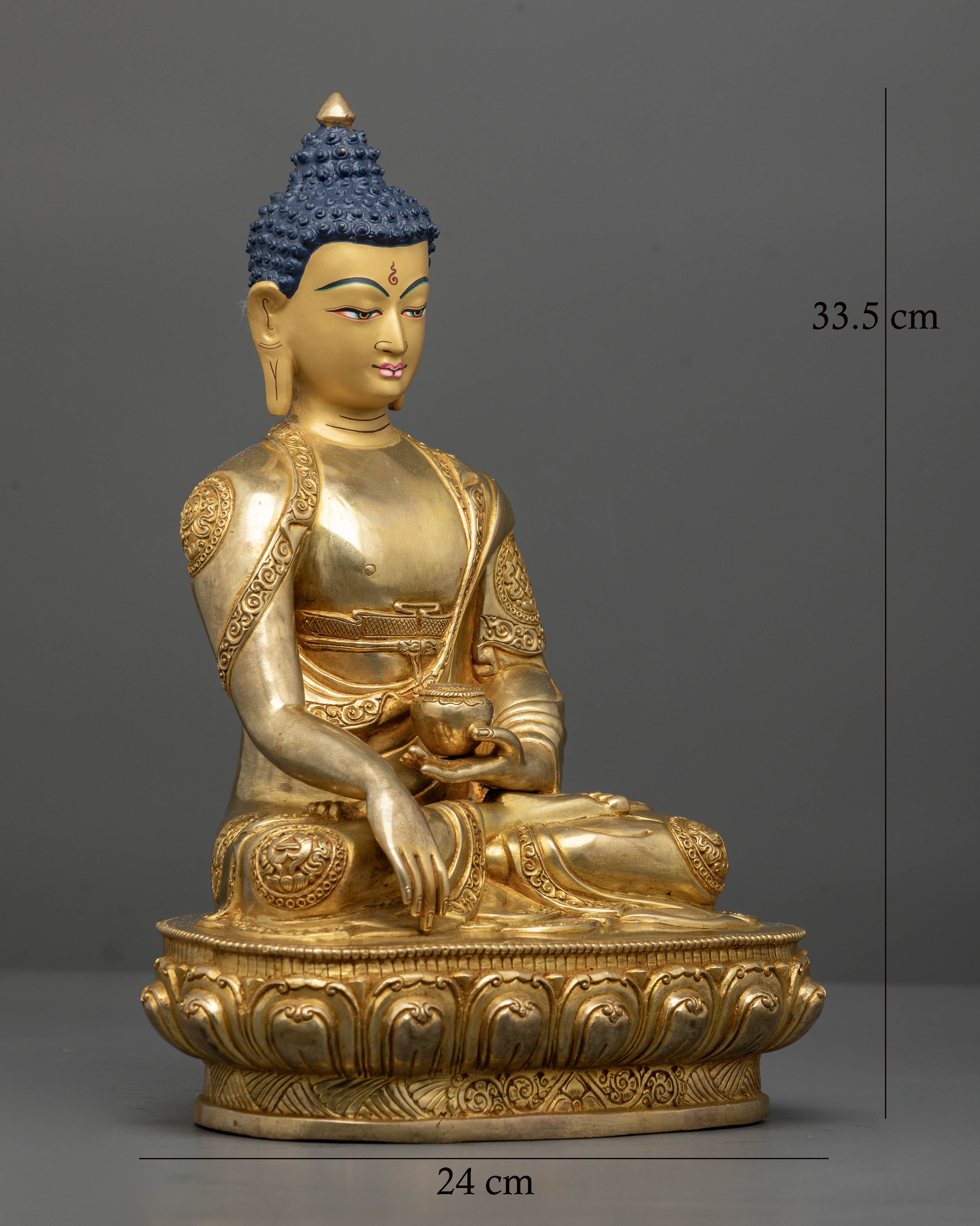 Shakyamuni Buddha showing intricately carved monastic robes and lotus pedestal