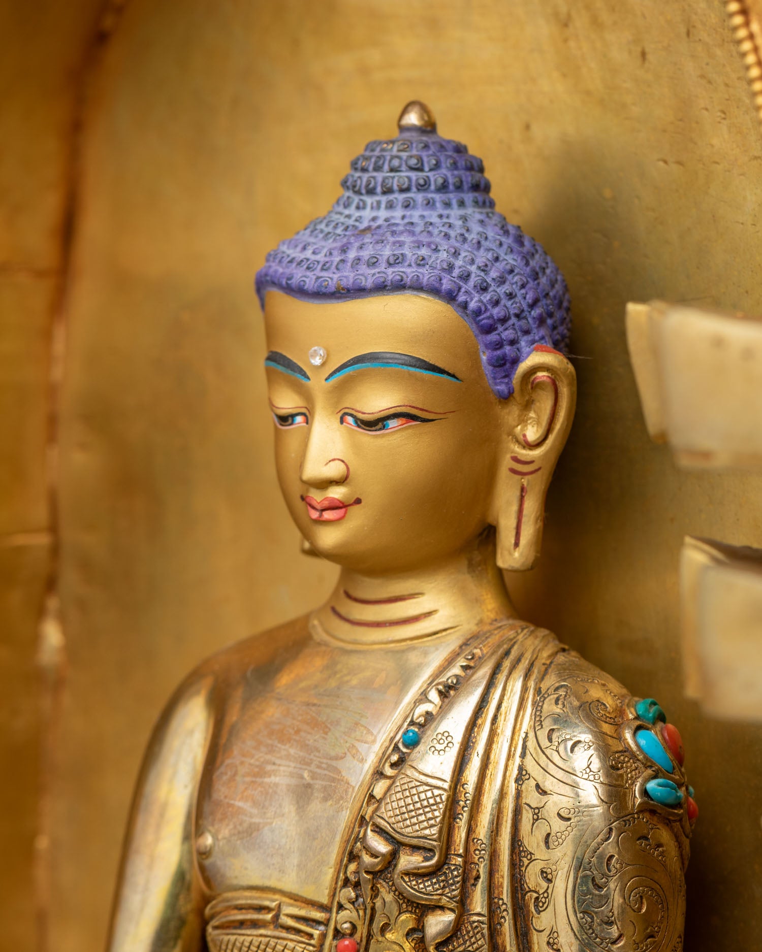 Shakyamuni Buddha detailed side close-up with turquoise and coral inlay work