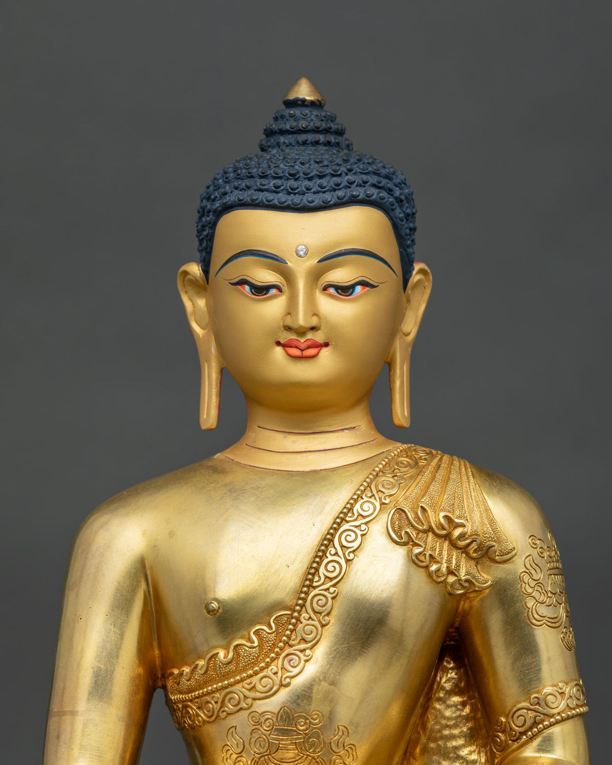 Shakyamuni Buddha statue 24K gold painted face detailed.