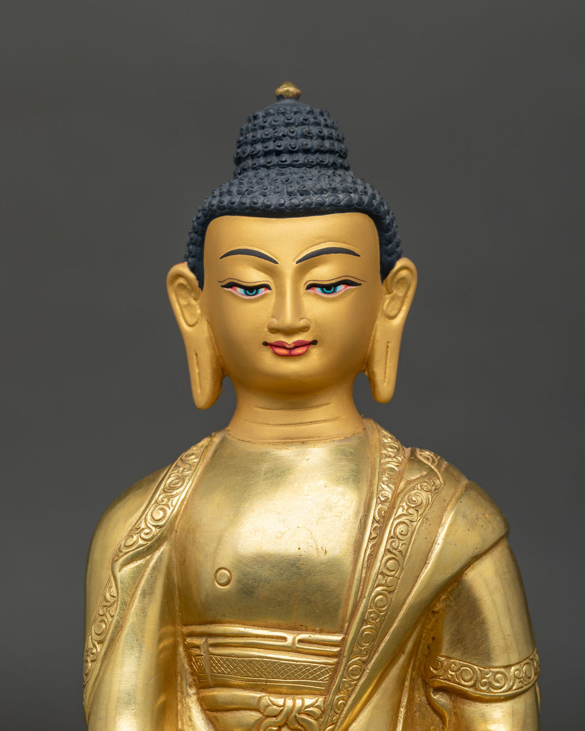 Shakyamuni Buddha statue 24K gold painted face serene expression Nepal.
