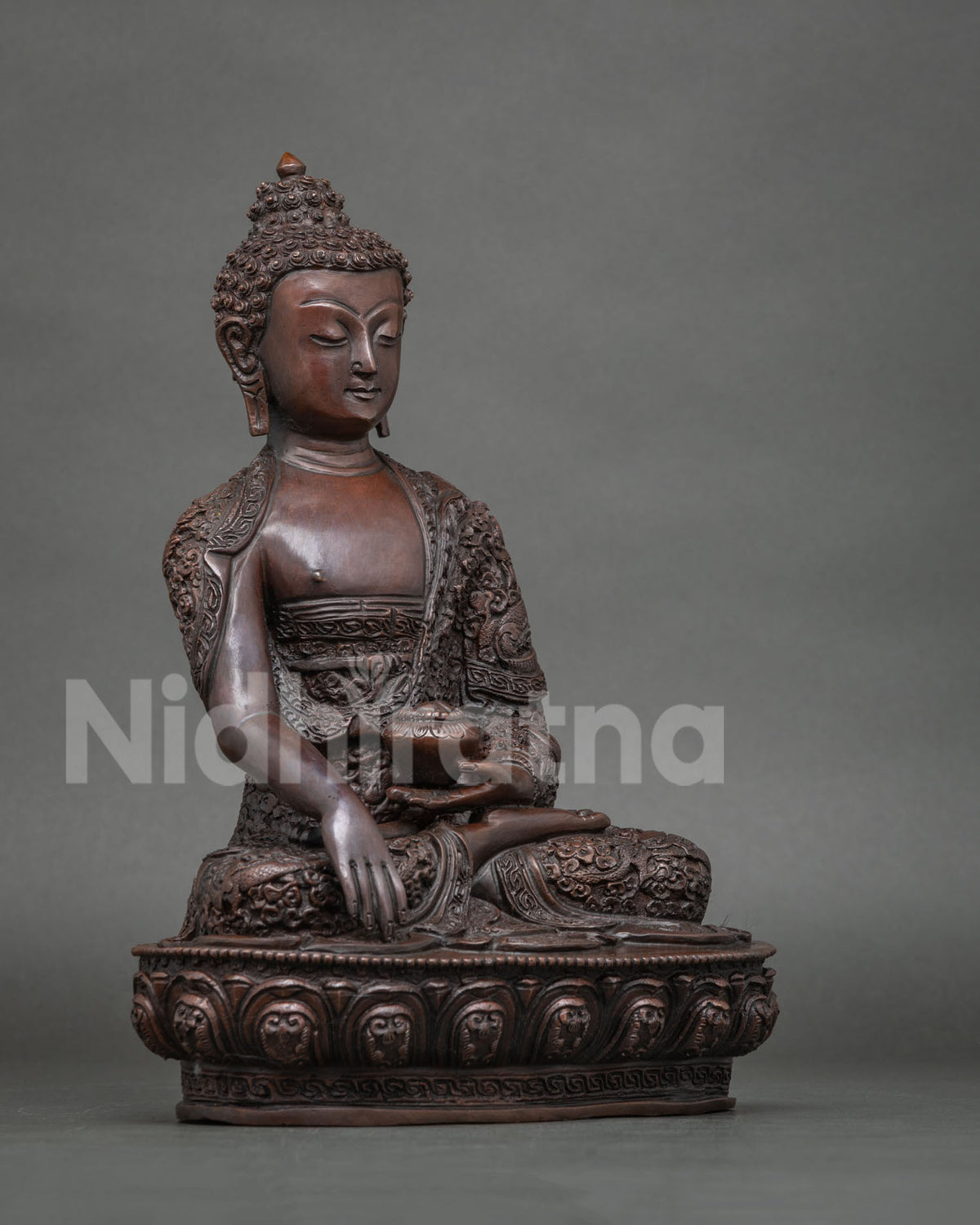 Shakyamuni Buddha statue in the Bhumisparsha Mudra holding a traditional begging bowl symbolizing renunciation and enlightenment.