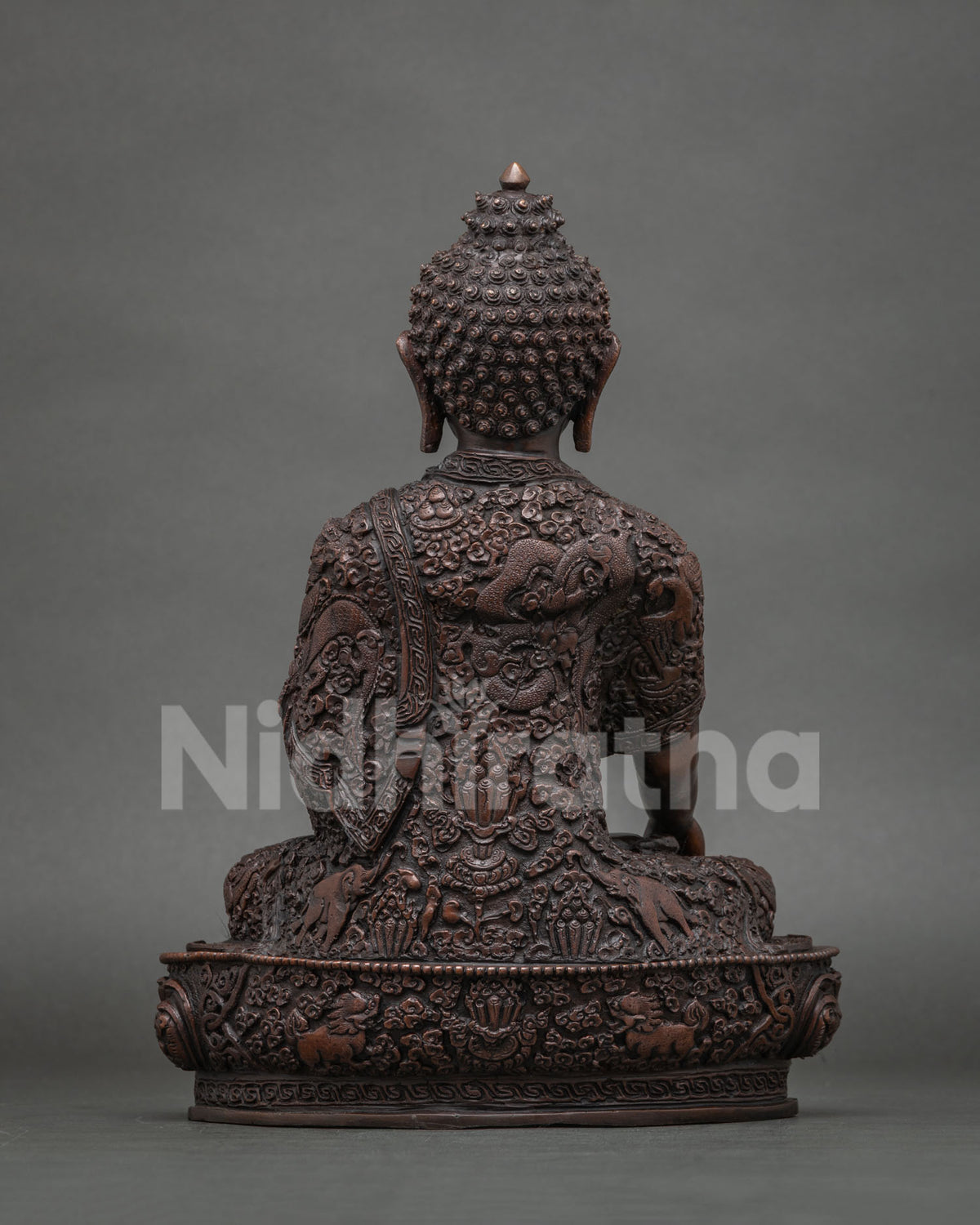 Shakyamuni Buddha statue featuring a hand carved monk robe with floral designs roaming dragon auspicious symbols and celestial elephants.
