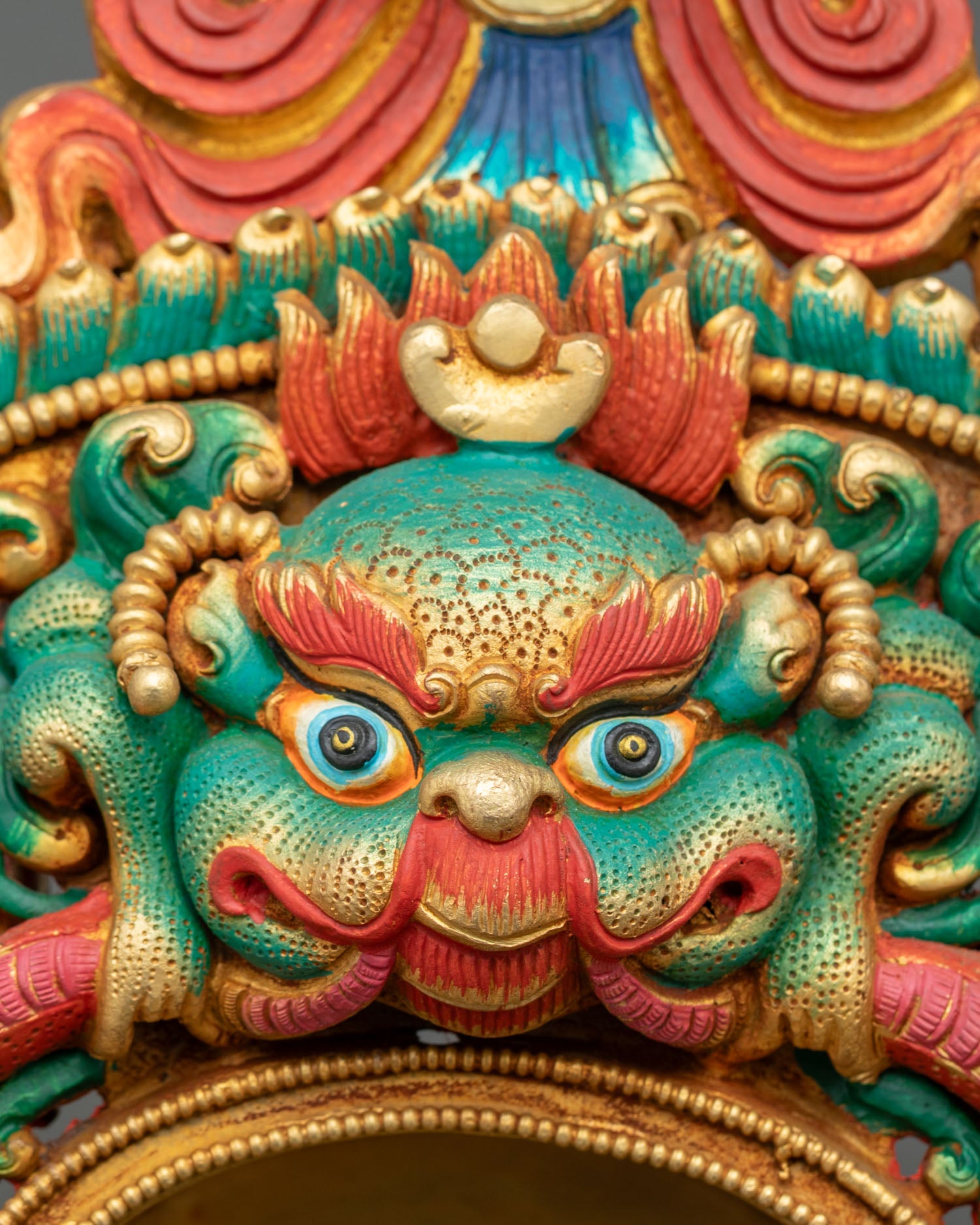 Shakyamuni Buddha statue close-up of Kirtimukha face on ornate torana