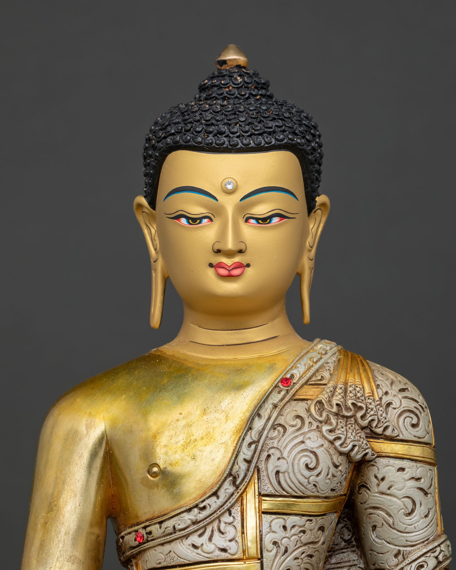 Shakyamuni Buddha Statue close up of serene gold painted face with intricate hand painted details