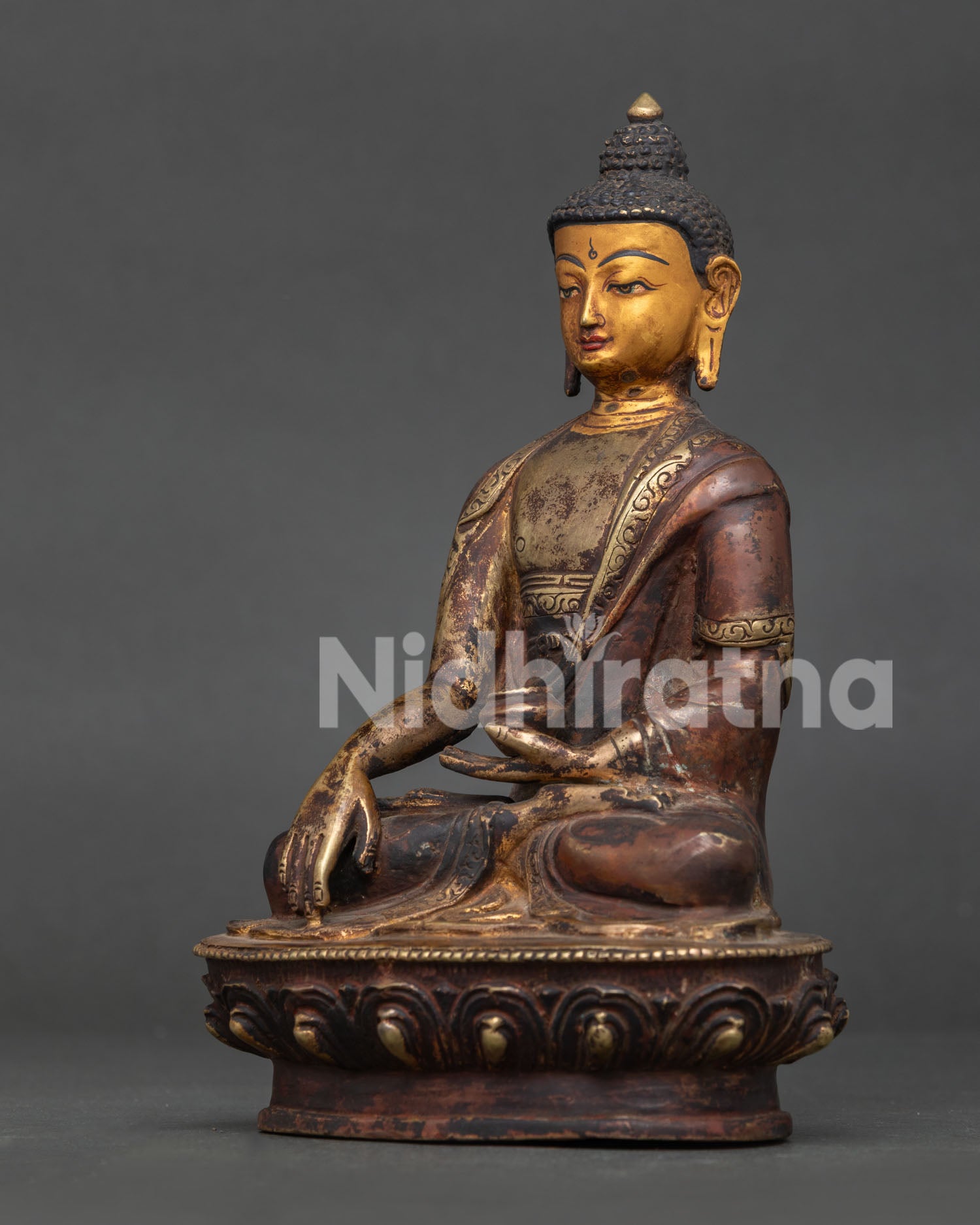 Shakyamuni Buddha Statue Detail Showing Handcarved Monk’s Robe and Alms Bowl.