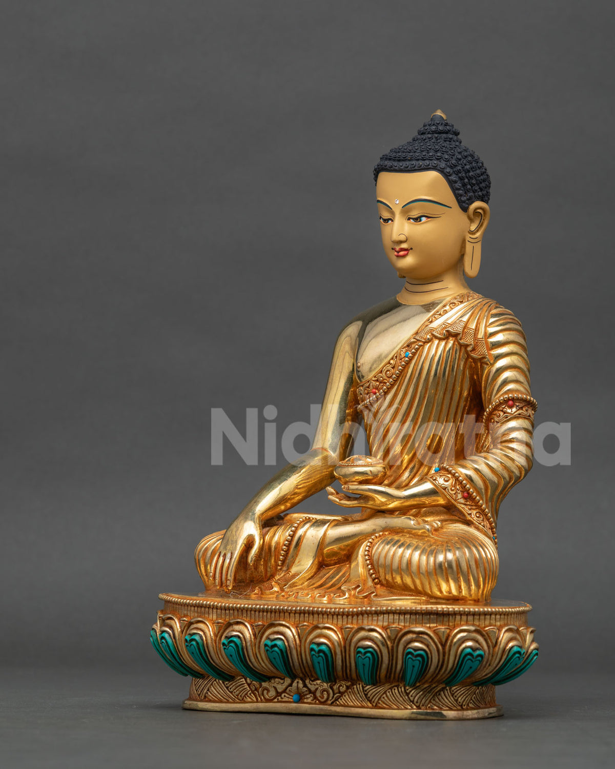 Shakyamuni Buddha statue earth touching mudra and patra bowl detail.