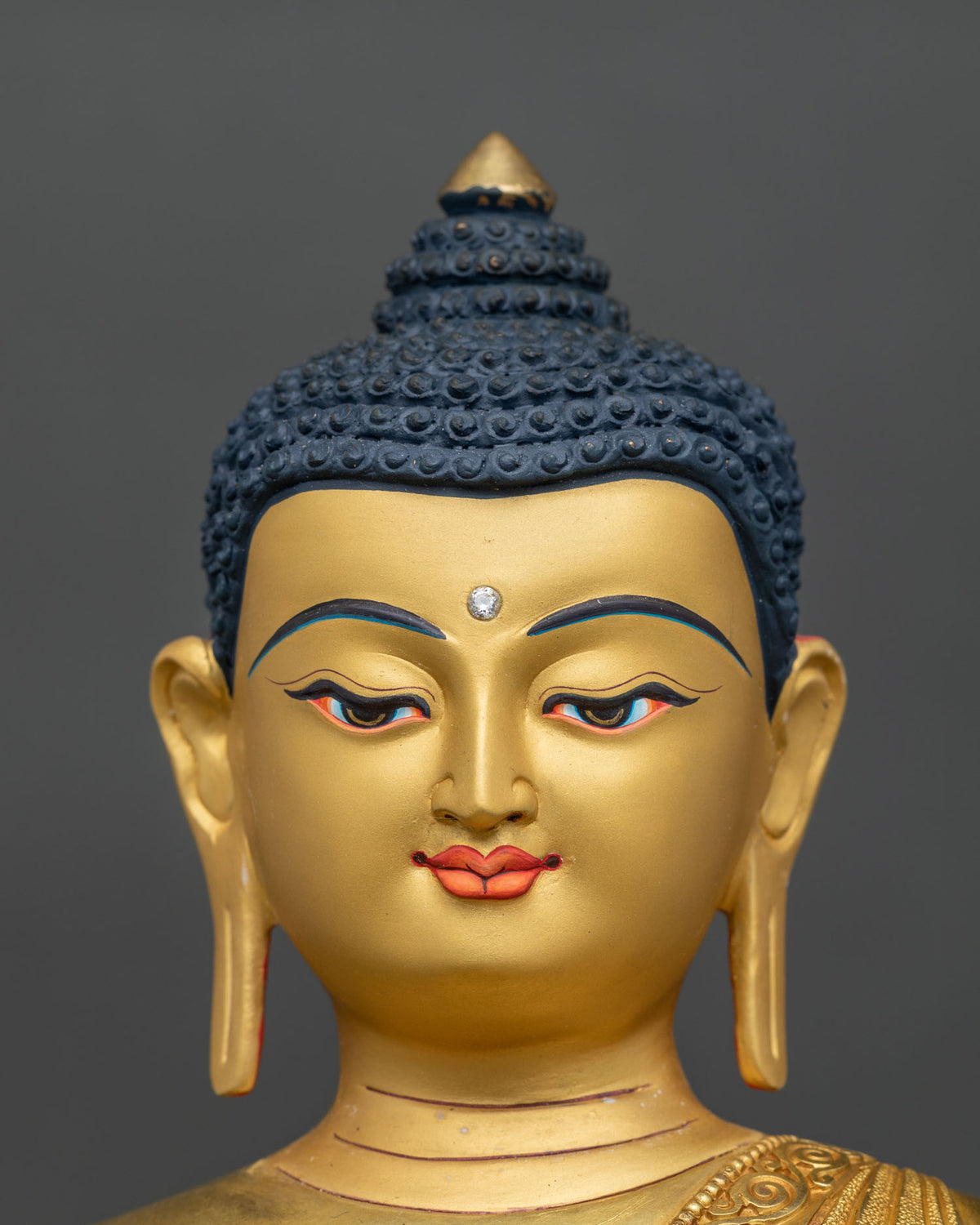 Shakyamuni Buddha statue engraved auspicious symbols on robe side detail.