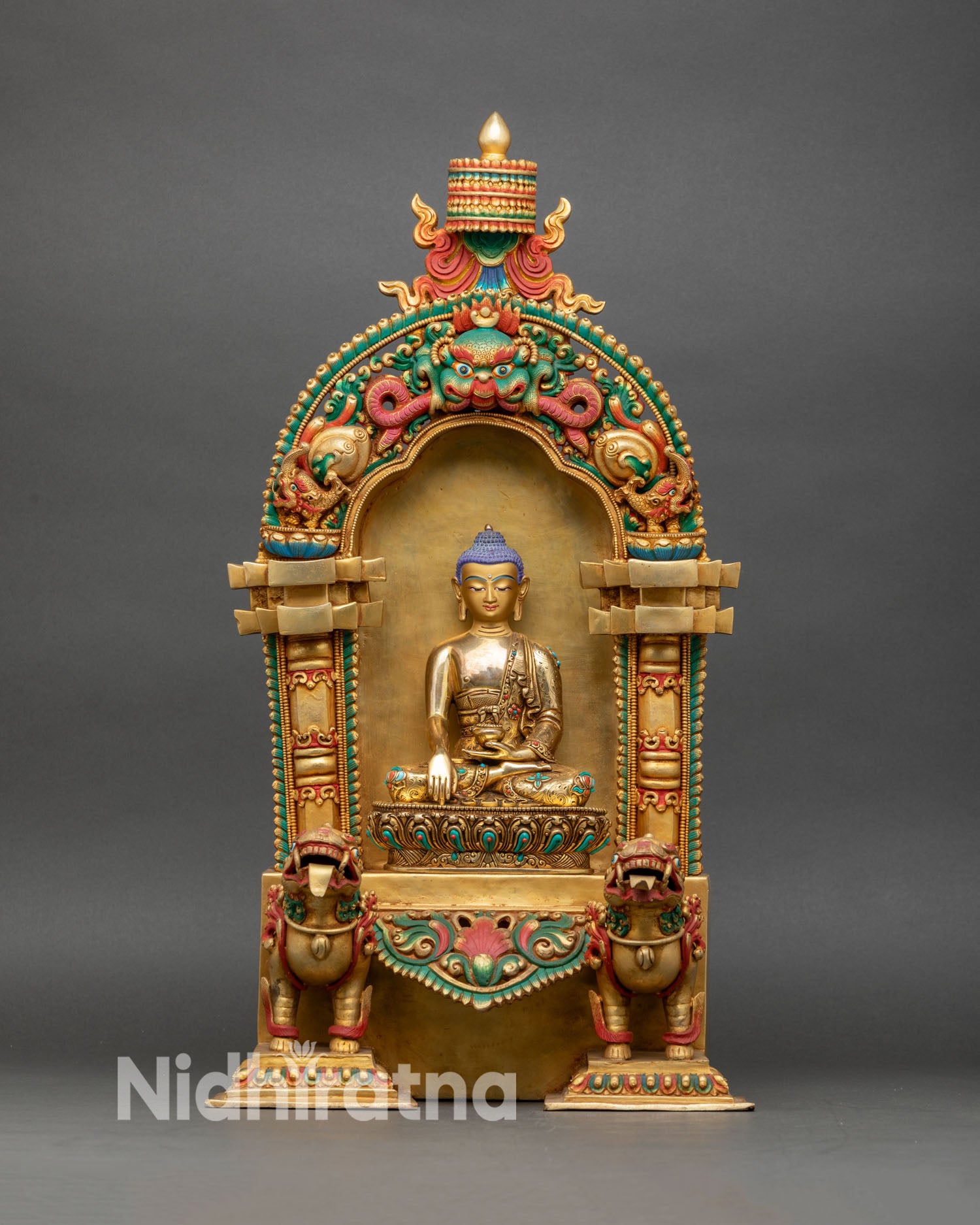 Shakyamuni Buddha statue front view with gold gilded lotus throne and snow lions