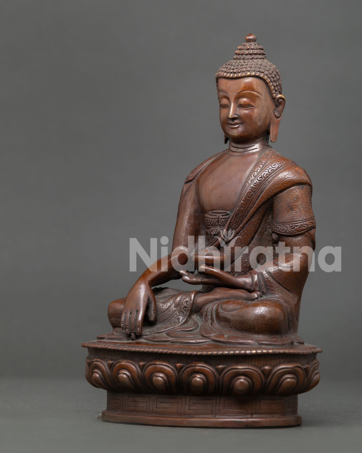 Shakyamuni Buddha statue handcrafted by Newari artisan from Patan Nepal with oxidized copper finish and Himalayan Buddhist craftsmanship.