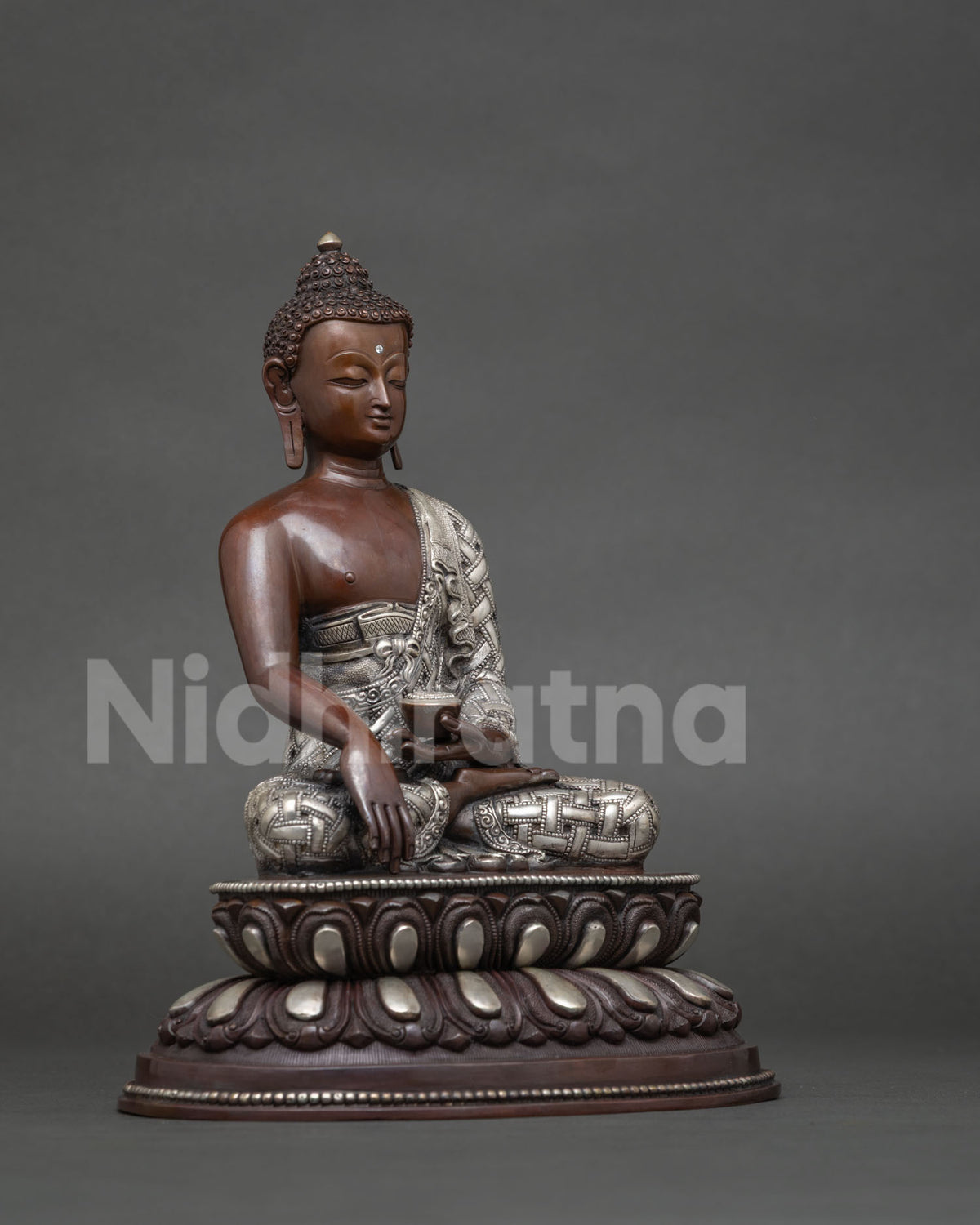 Shakyamuni buddha statue handcrafted by newari artist in patan nepal with silver plated details.
