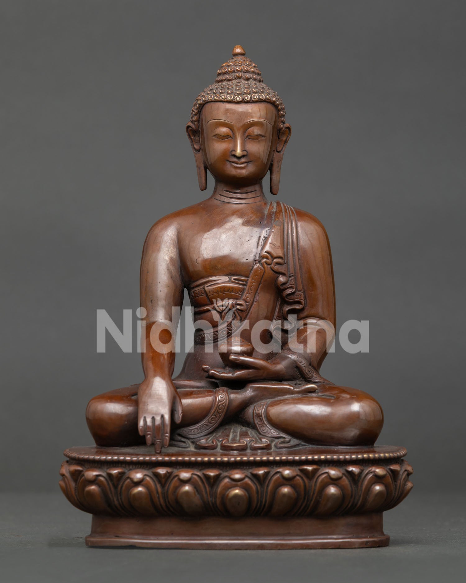 Shakyamuni Buddha statue handcrafted in Nepal from copper with oxidized finish seated on lotus throne.