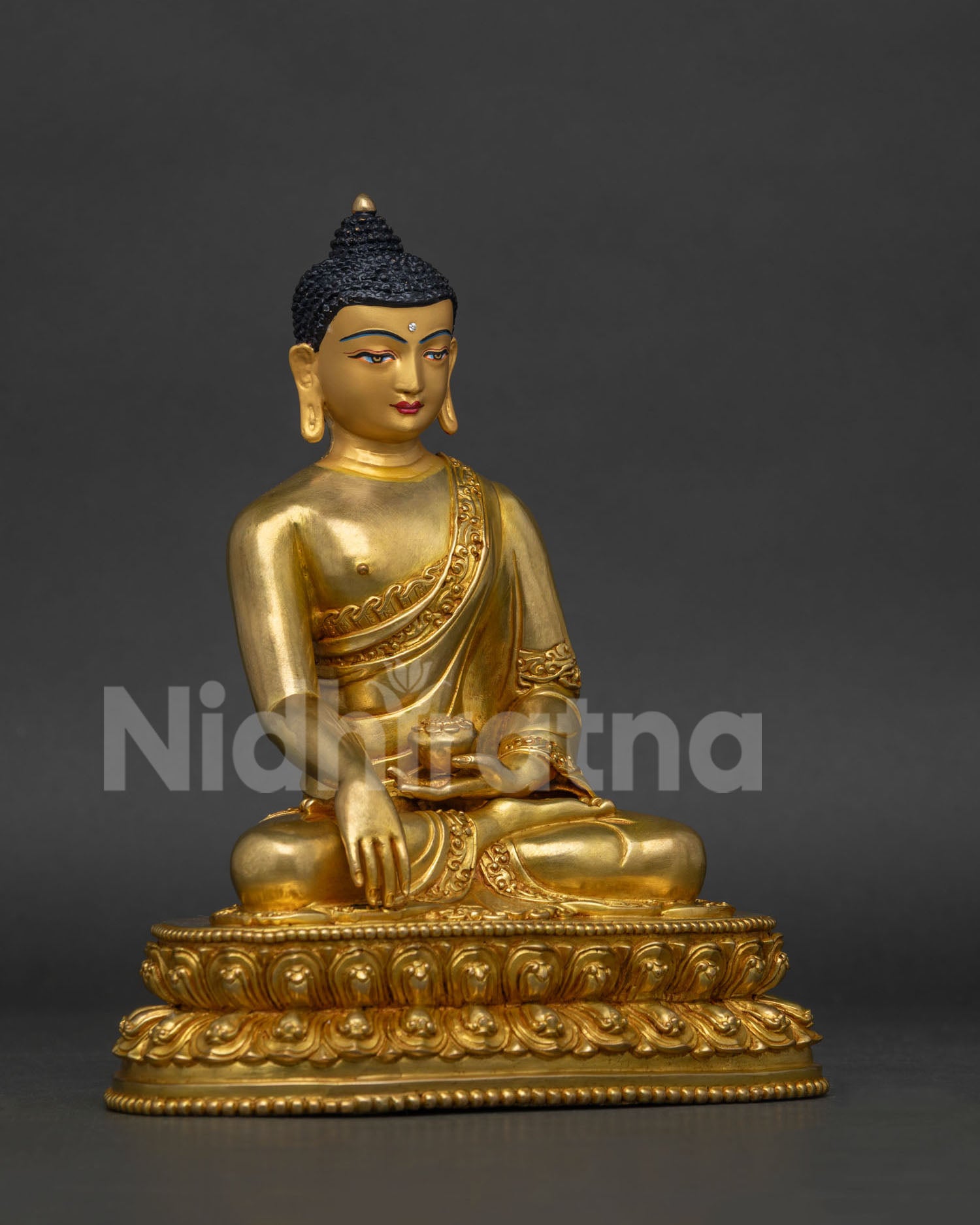 Shakyamuni Buddha statue holding begging bowl in Bhumisparsha Mudra.