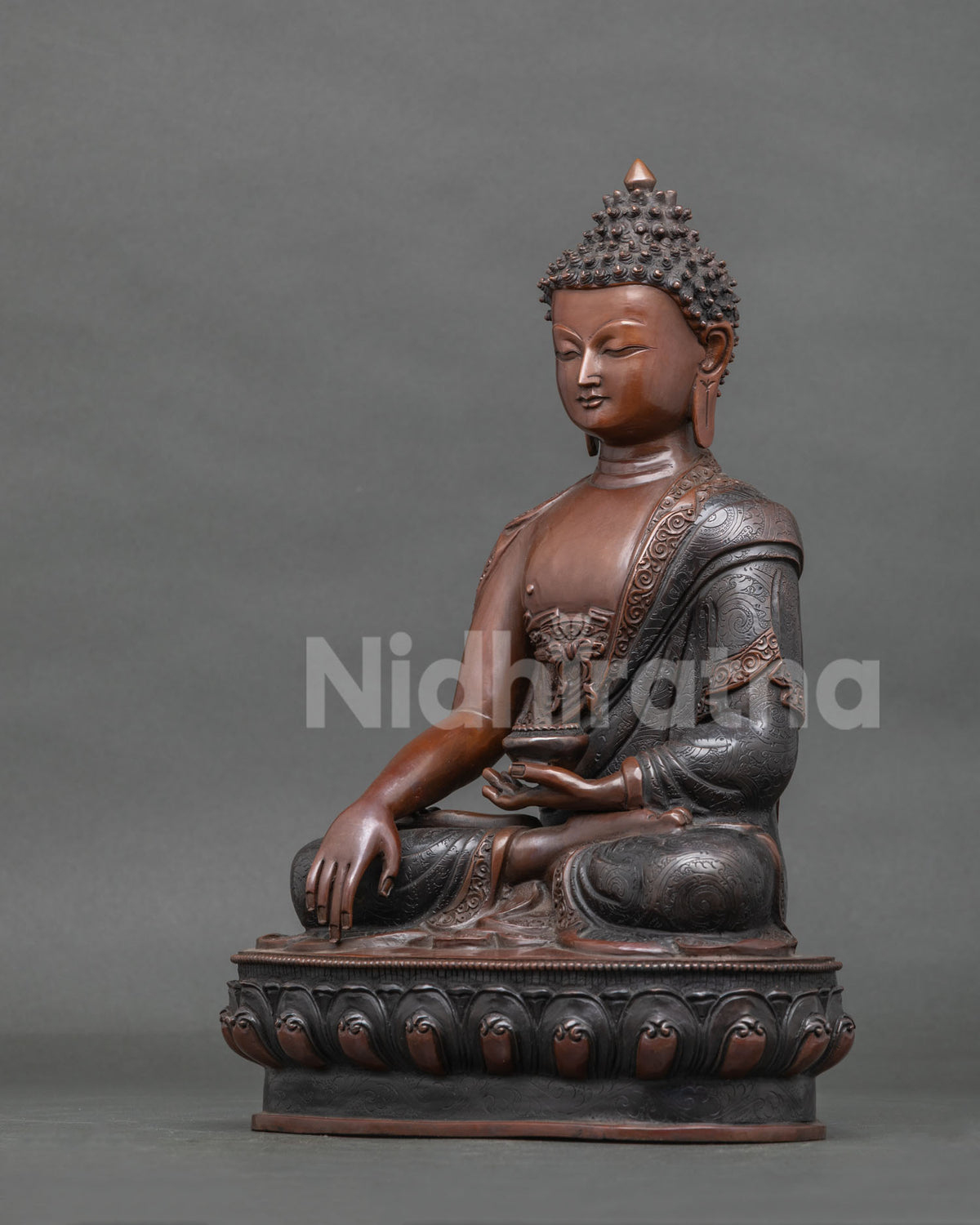 Shakyamuni Buddha statue holding a begging bowl symbolizing the monastic path.