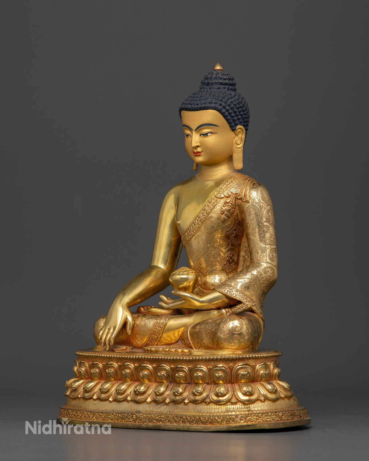 Shakyamuni Buddha statue in Bhumisparsha Mudra holding sacred alms bowl symbolizing enlightenment