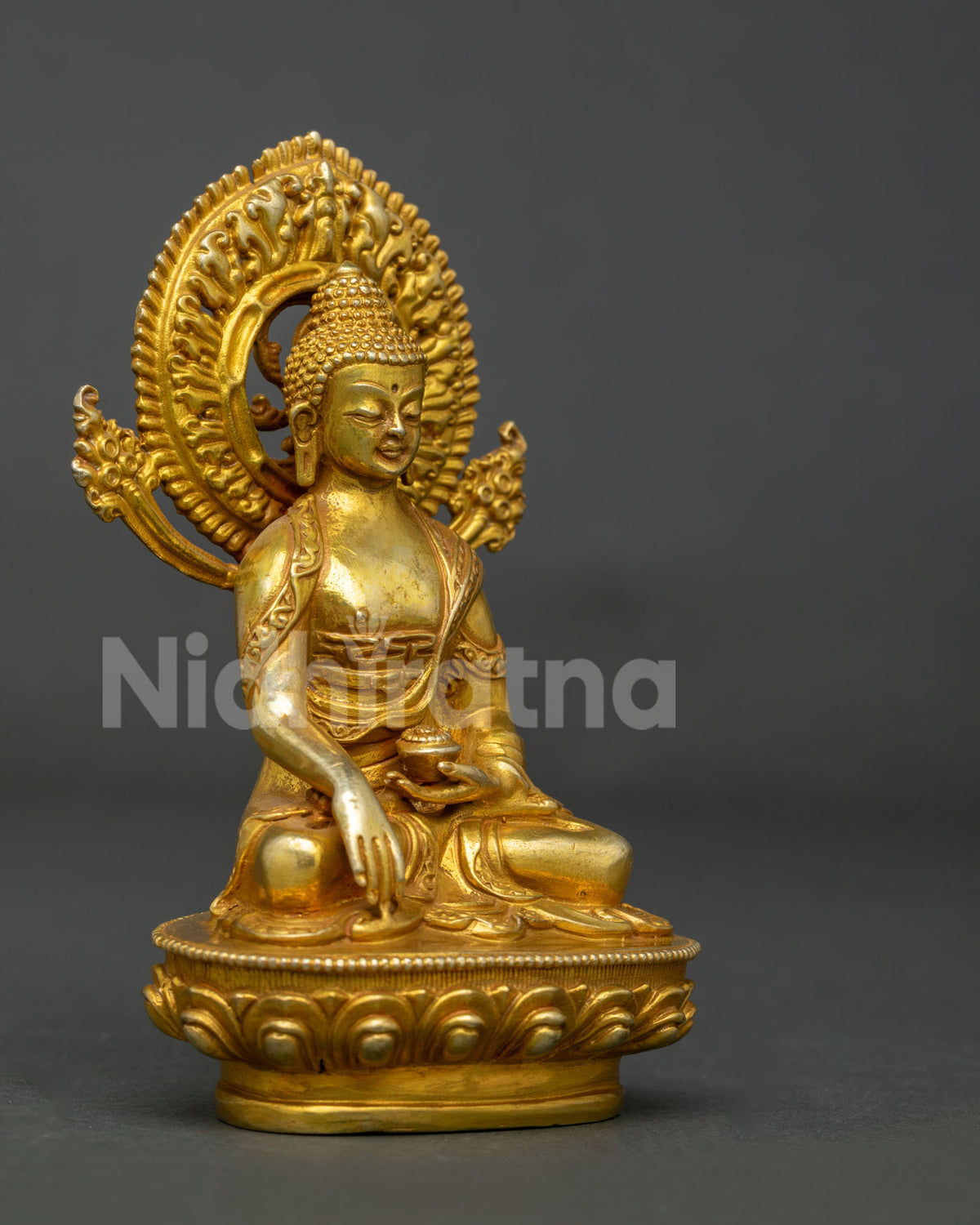 Shakyamuni Buddha statue in copper with gold fire gilded finish and begging bowl.