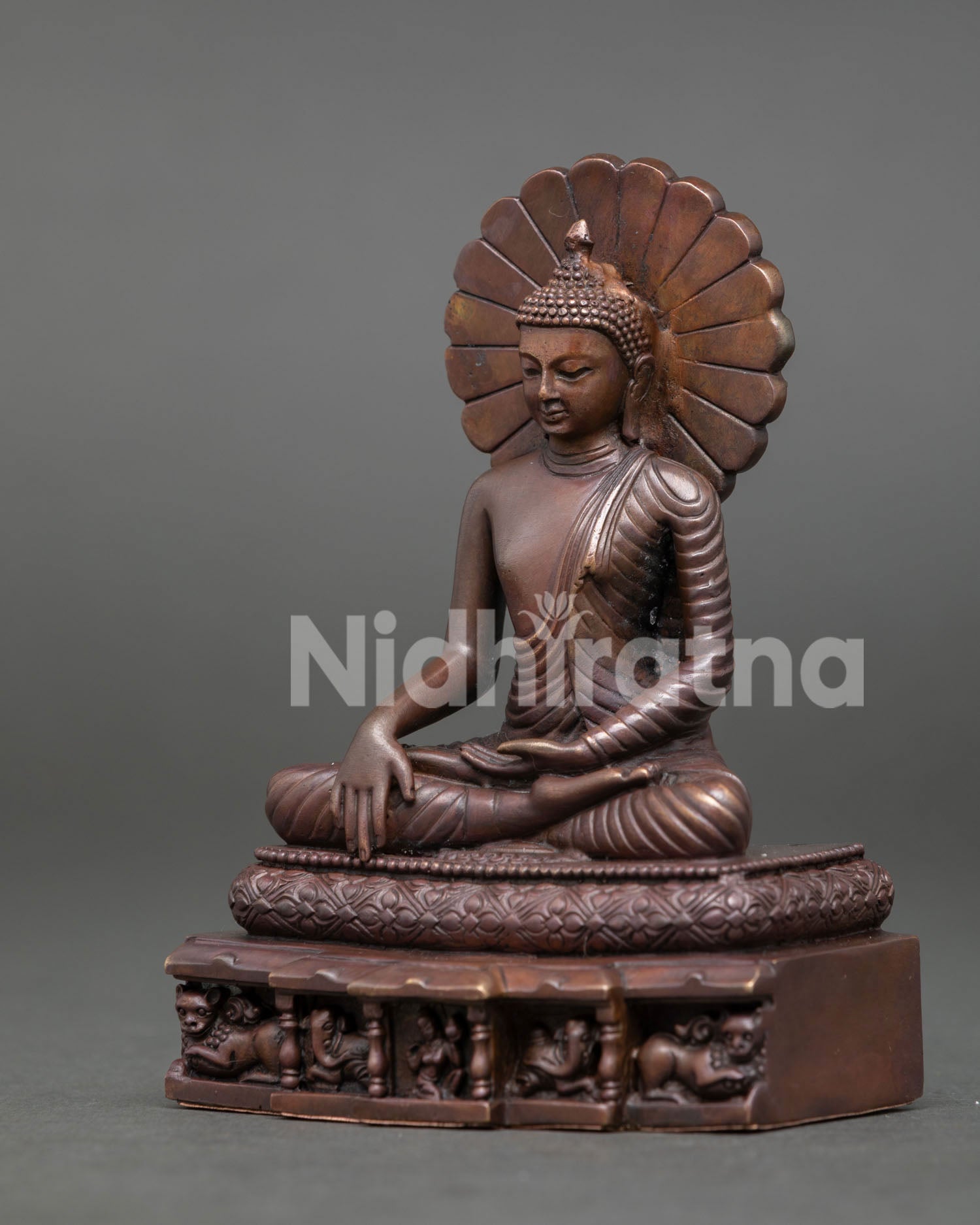 Shakyamuni Buddha statue in earth touching mudra wearing detailed monk robe on lion throne.