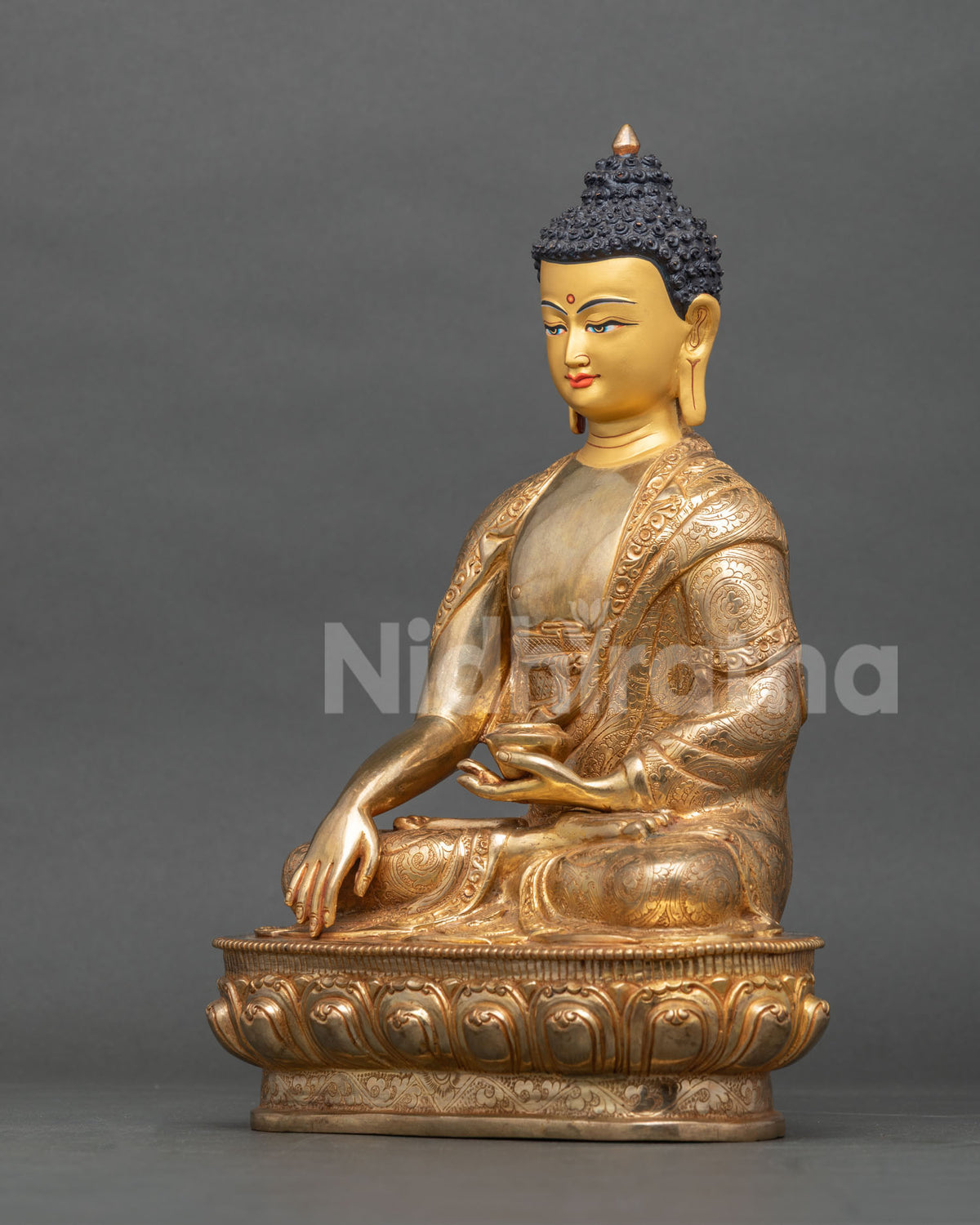 Shakyamuni Buddha statue left side view with lotus pedestal and monastic robe.