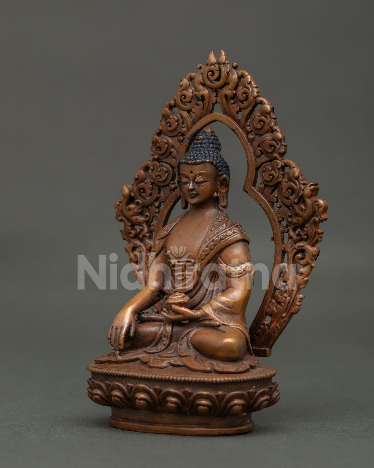 Shakyamuni Buddha statue ornate halo and detailed lotus pedestal Nepalese Buddhist art.