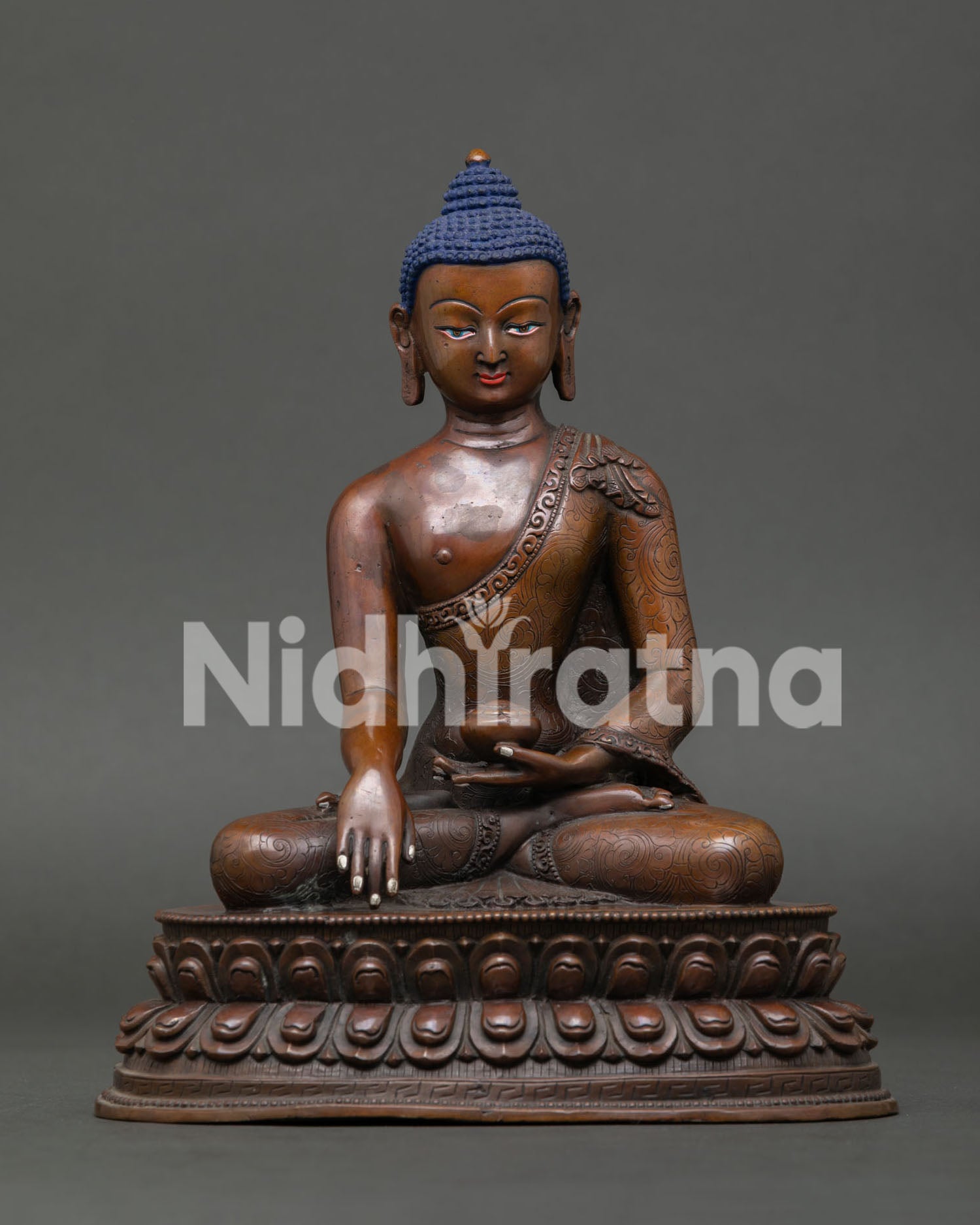 Shakyamuni Buddha statue seated on double lotus pedestal with oxidized copper finish from Nepal.