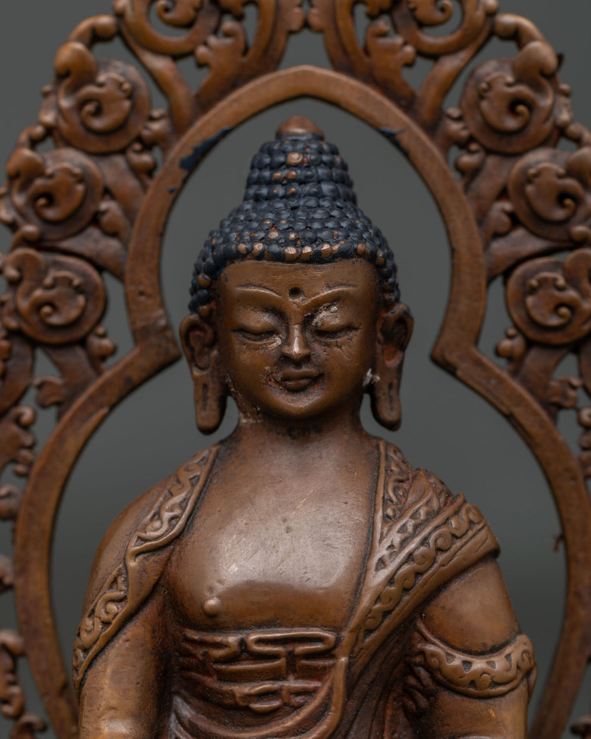 Shakyamuni Buddha statue serene face and intricate hand carved monk robe.