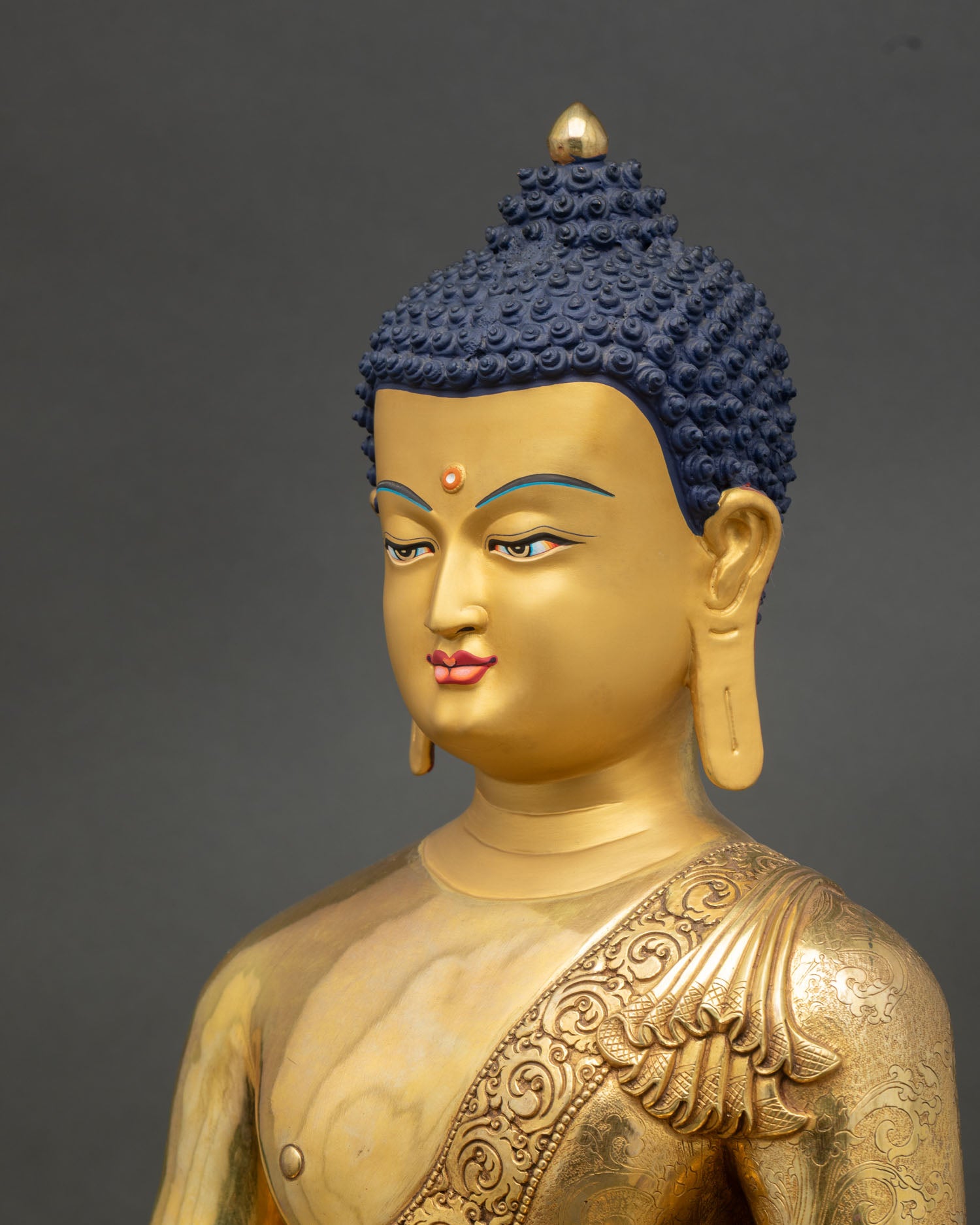 Side close up Shakyamuni Buddha statue, detailed craftsmanship showing ornate halo and copper gold finishing